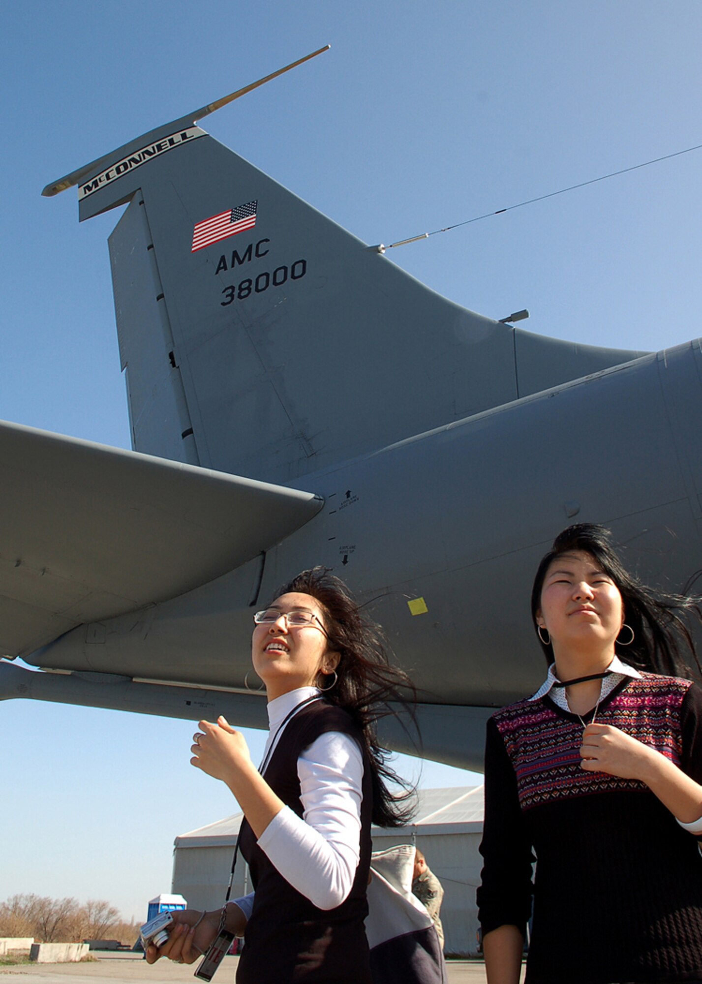 Jangyl Ismailova and Asel Botpayeva, explore the flightline and the fleet of KC-135 Stratotankers at Manas Air Base, Kyrgyzstan, March 26. Ms. Ismailova and Ms. Botpayeva, are students at the American University of Central Asia in Bishkek. They visited Manas with other students and faculty for an orientation tour and dinner hosted by the 376th Air Expeditionary Wing Public Affairs office. The visit provided the students a look at the missions carried out daily in support of operations in Afghanistan, while building friendships with coalition personnel deployed here. (U.S. Air Force/Tech. Sgt. Phyllis Hanson)