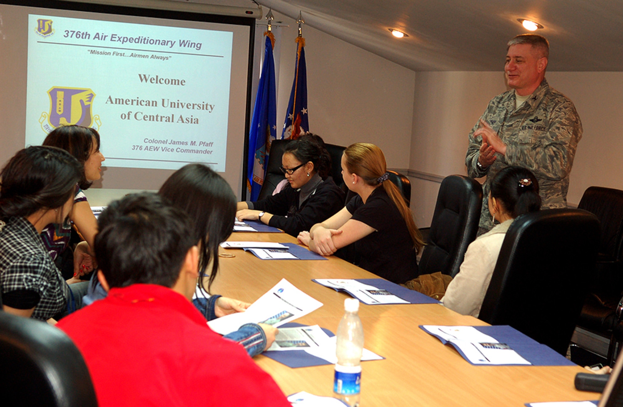 Col. James Pfaff, the 376th Air Expeditionary Wing vice commander, gives a mission briefing to 15 American University of Central Asia students and faculty who visited Manas Air Base, Kyrgyzstan, March 26. The visitors were given an orientation tour and dinner hosted by the 376th AEW Public Affairs Office. The visit provided the students a look at the missions carried out daily in support of operations in Afghanistan, while building friendships with coalition personnel deployed here. (U.S. Air Force/Tech. Sgt. Phyllis Hanson)