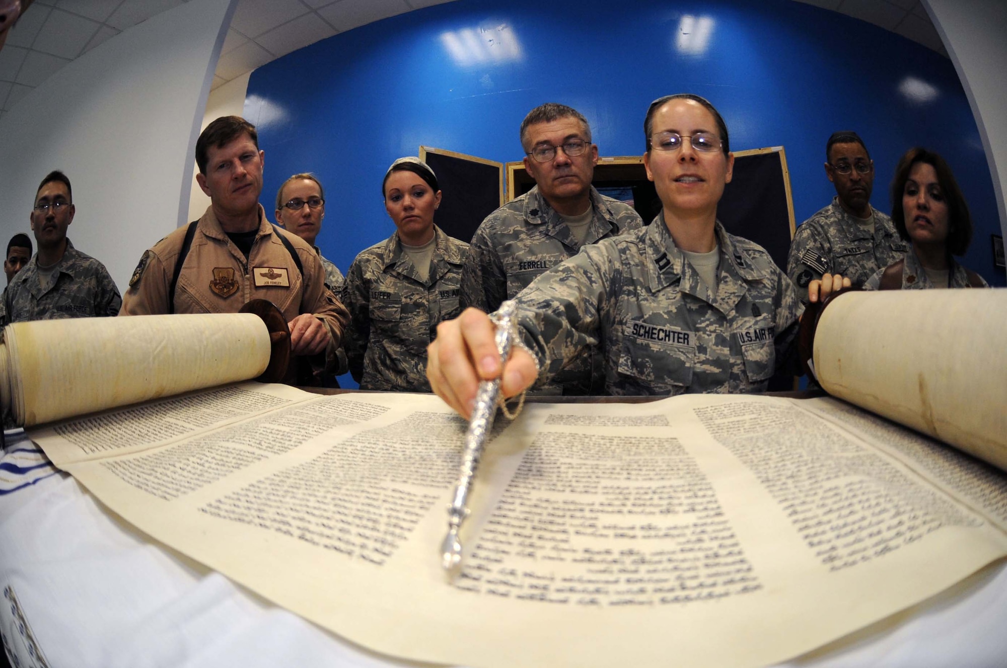 JOINT BASE BALAD, Iraq -- Chaplain (Capt.) Sarah Schechter, 332nd Air Expeditionary Wing rabbi, describes the newly arrived Jewish Torah following a Torah dedication ceremony at Gilbert Memorial Chapel here March 21. A Torah is a big parchment leather scroll on which the Five Books of Moses are handwritten in Hebrew. For thousands of years, this is how Jews have maintained their law, teachings, religion and society. (U.S. Air Force photo/Senior Airman Elizabeth Rissmiller)