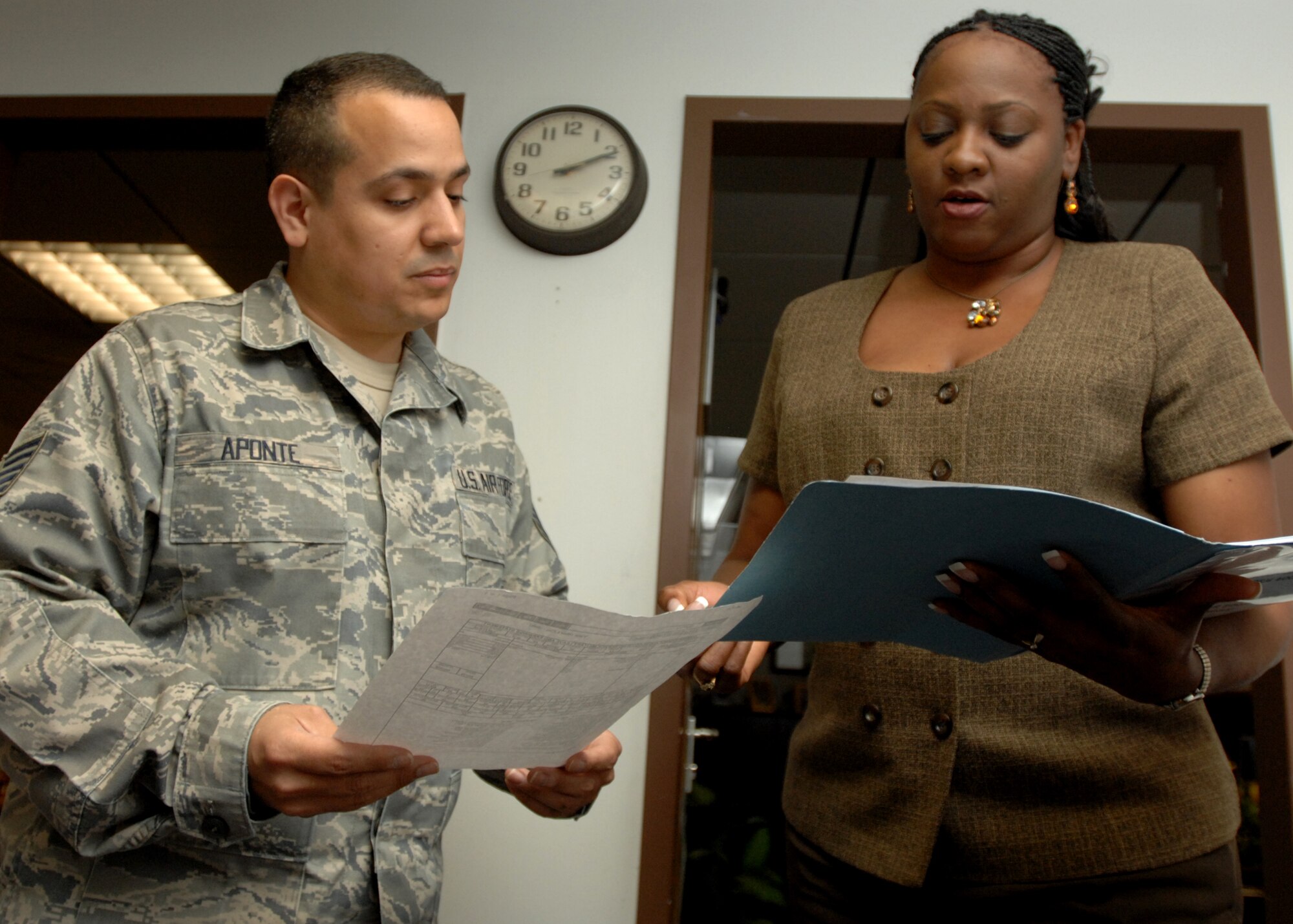 SPANGDAHLEM AIR BASE, Germany -- Dana Hodges, 52nd Fighter Wing school liaison officer, explains to Tech. Sgt. Jason Aponte, 52nd Mission Support Group, how to fill out a school lunch application March 29, 2009. As a school liaison officer, Mrs. Hodges acts as a link between military members and Department of Defense Dependents School - Europe for the 52nd Fighter Wing. (U.S. Air Force photo by Senior Airman Jenifer H. Calhoun)