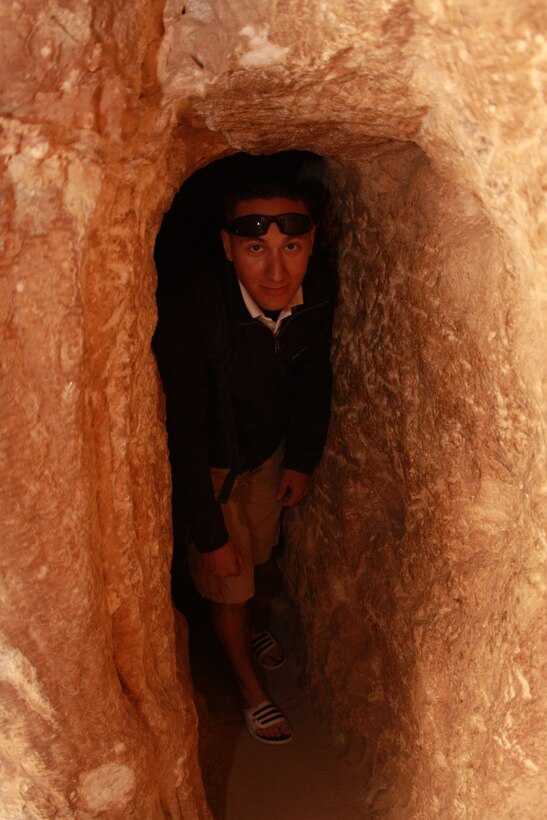 Lance Cpl. Aaron Kristopik, a paralegal with the Combat Center’s Staff Judge Advocate, squeezes through a hole in Mitchell’s Cavern. Kristopik, an avid traveler began his sightseeing journey around southern California with a trip to the cavern.