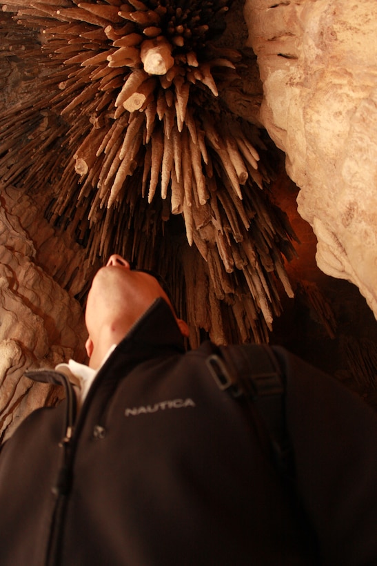 Lance Cpl. Aaron Kristopik, a paralegal with the Combat Center’s Staff Judge Advocate, looks up at a large formation of stalactites. Stalactites are formed over thousands of years from ceilings of caves.