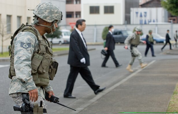 Staff Sgt. Jay King, 374th Security Force Squadron, searches for unexploded ordnance with the Japanese National Police-Fussa Division during a joint UXO response exercise at Yokota Air Base, Japan, March 27. (U.S. Air Force photo/Osakabe Yasuo) 