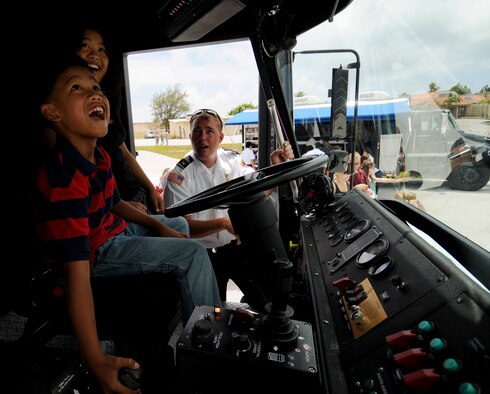 Will O'meara, Andersen Air Force Base, Guam, Fire and Emergency Services Flight station chief, shows spectators the functions of the fire engine during the Open House here Mar. 28 The event showcased the Fire Unit, Explosive Ordnance Disposal Unit, K-9 Unit, a KC-135, a F-22 Raptor, and a B-2 Spirit. (U.S. Air Force photo/Airman 1st Class Courtney Witt) 