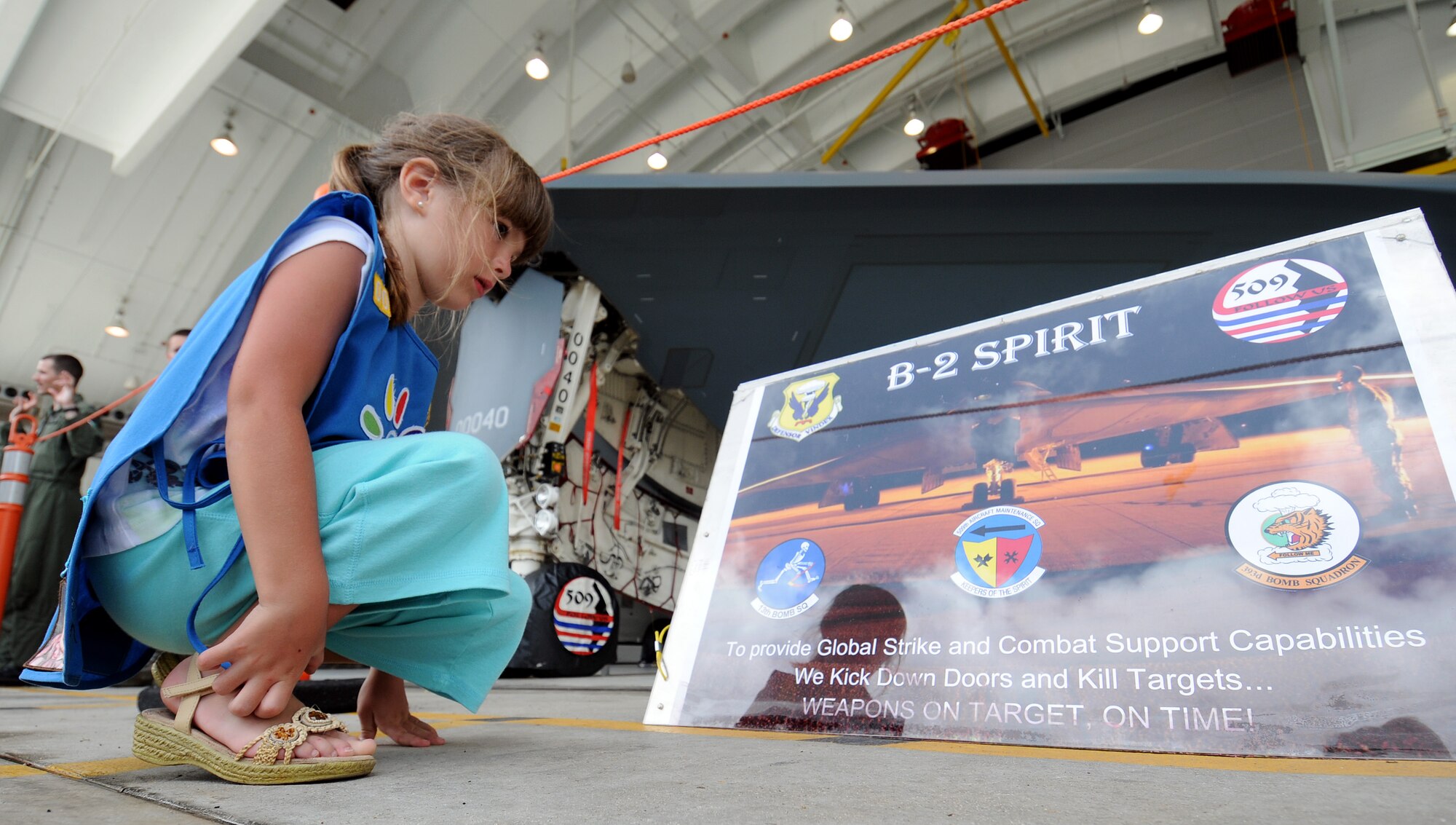 ANDERSEN AIR FORCE BASE, Guam - Katie Underwood, with Daisy Troop 005, reads about the B-2 Spirit during the Open House here Mar. 28. The Open House was open to the Armed Forces Committee, Andersen Civilian Advisory Council, Andersen Boy and Girl Scouts, Air Force Junior Reserve Officers Training Corps, Military ID cardholders and dependents. (U.S. Air Force photo by Airman 1st Class Courtney Witt)