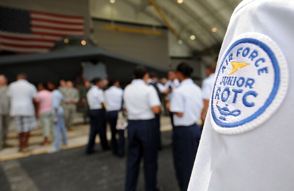 John F. Kennedy's Air Force Junior Reserve Officers Training Corps gather around the B-2 Spirit on display at the Andersen Air Force Base, Guam, Open House Mar. 28 for a quick photo and a brief description of the aircraft. More than 45 JROTC members came out to the base to receive a first-hand look at some of the Air Force's premier aircraft. (U.S. Air Force photo/Airman 1st Class Courtney Witt) 