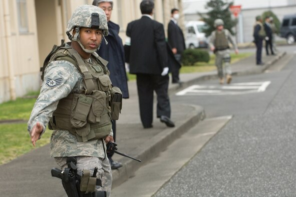 Staff Sgt. Jay King, 374th Security Force Squadron, searches for unexploded ordnance with Japanese National Police-Fussa Division during the joint UXO response exercise at Yokota Air Base, Japan, March 27. (U.S. Air Force photo/Osakabe Yasuo) 