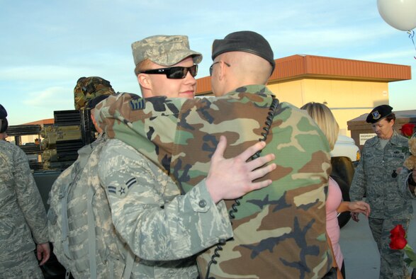 Airman 1st Class Joseph Edwards, with the 95th Security Forces Squadron, receives a hug from a fellow 95th SFS Airman during a welcome home reception March 13. Base leadership was also present during the reception. (U.S. Air Force photo/Lisa Camplin)