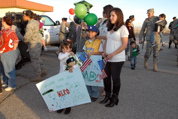 Ana Ventura and her family, waits for her husband, Tech. Sgt. Gerardo Ventura, 95th Security Forces Squadron, during a welcome home reception March 13 at the 95th SFS headquarters. The 95th SFS Key Spouses hosted the reception with a St. Patrick holiday theme. (U.S. Air Force photo/Lisa Camplin)