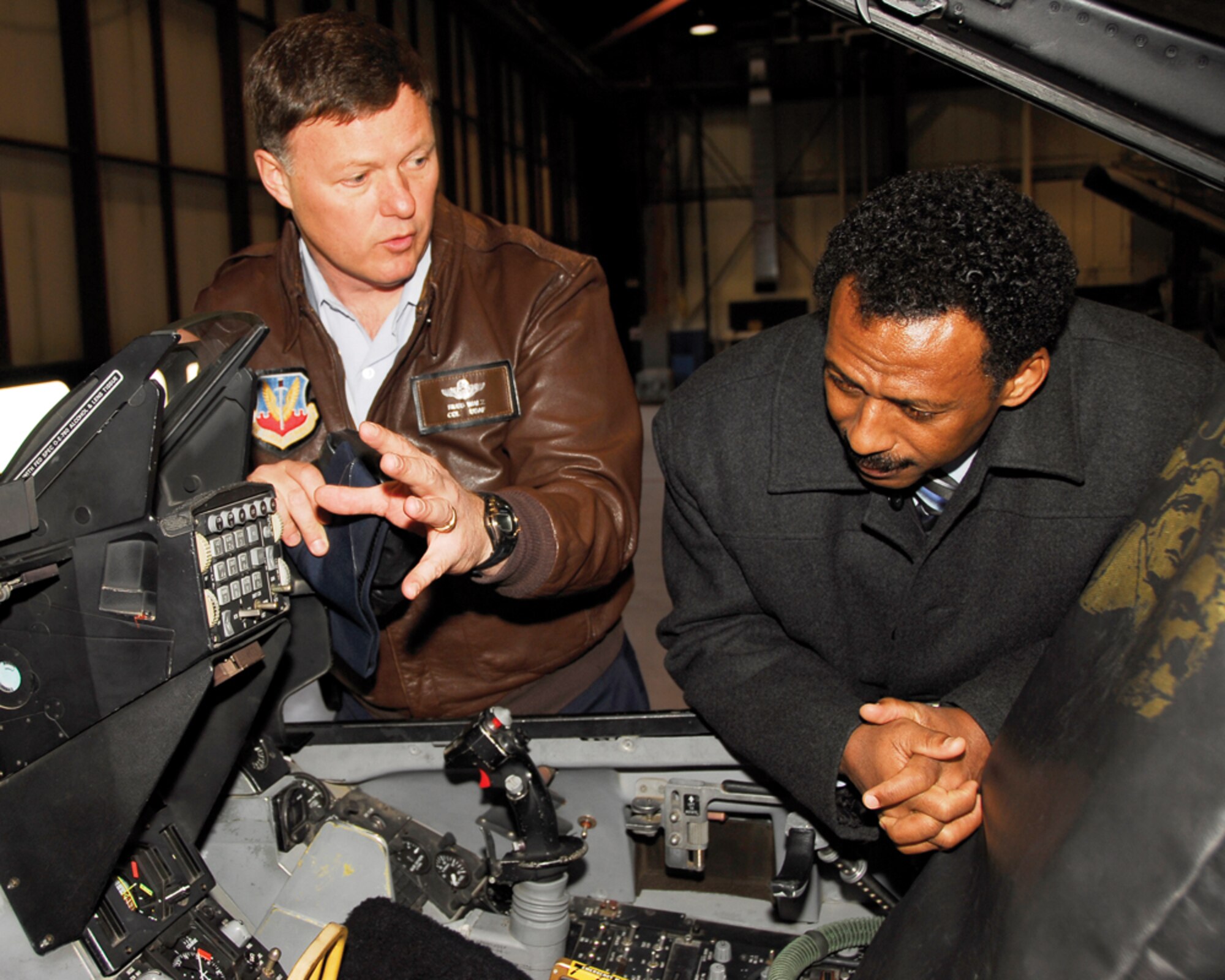 Col. Russ Walz, 114th Fighter Wing commander, explains the cockpit of the F-16 Fighter Falcon to Suriname Defense Minister Ivan Fernald here Feb. 25. Defense Minister Ivan Fernald and U.S. Ambassador Lisa Bobbie Schreiber Hughes were in South Dakota for a tour of the state as part of the Growth through Partnership program.