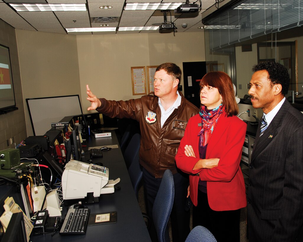 Col. Russ Walz, 114th Fighter Wing commander explains the operations inside the 114th Figher Wing Command Post to U.S. Ambassador Lisa Bobbie Schreiber Hughes and Suriname Defense Minister Ivan Fernald. Ambassador Schreiber Hughes and Defense Minister Fernald were in South Dakota as part of the Growth through Partnership program.