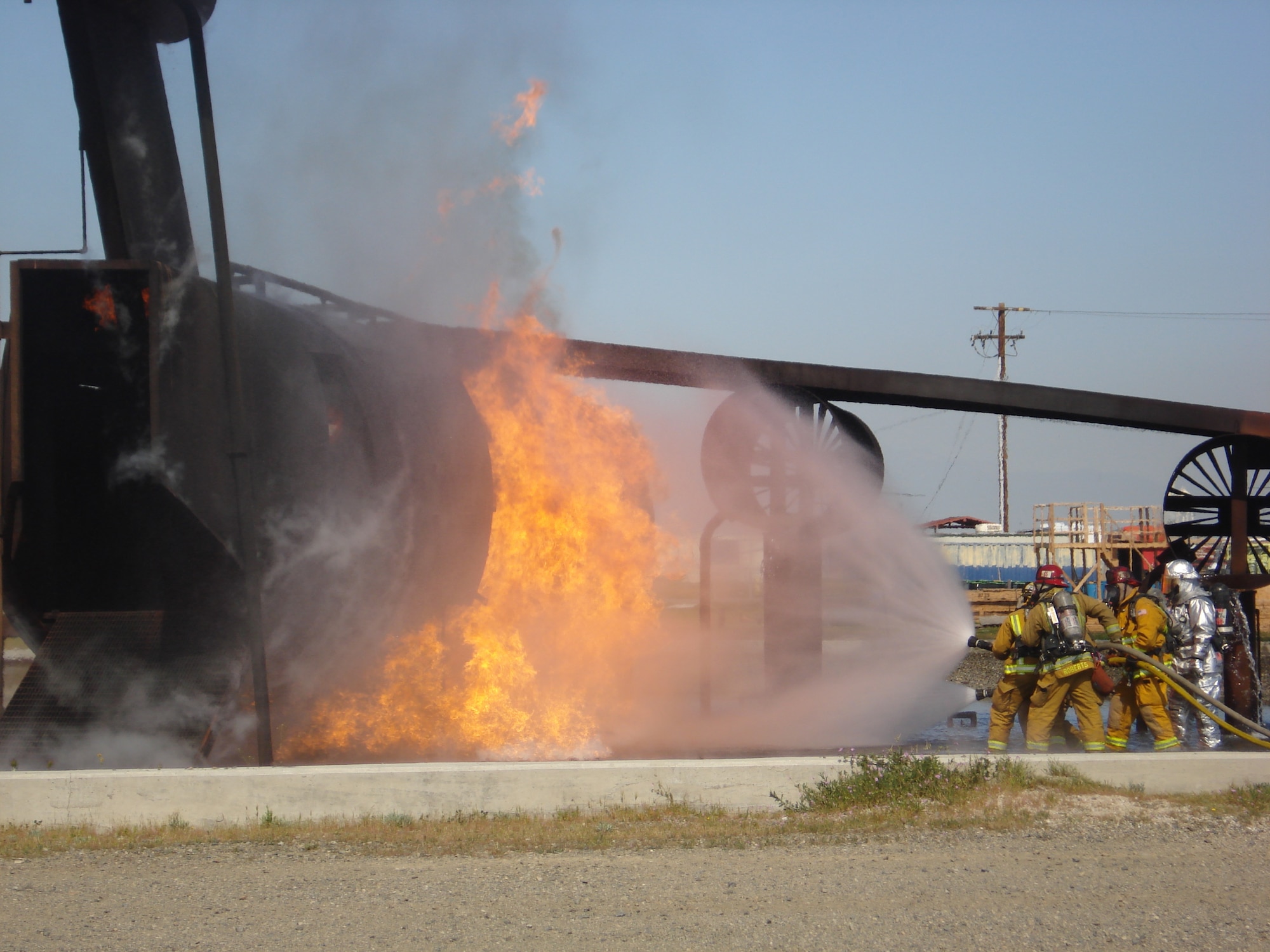 Fire fighters battle flames from a simulated crash. (U.S. Air Force photos by SSgt. Megan Crusher)