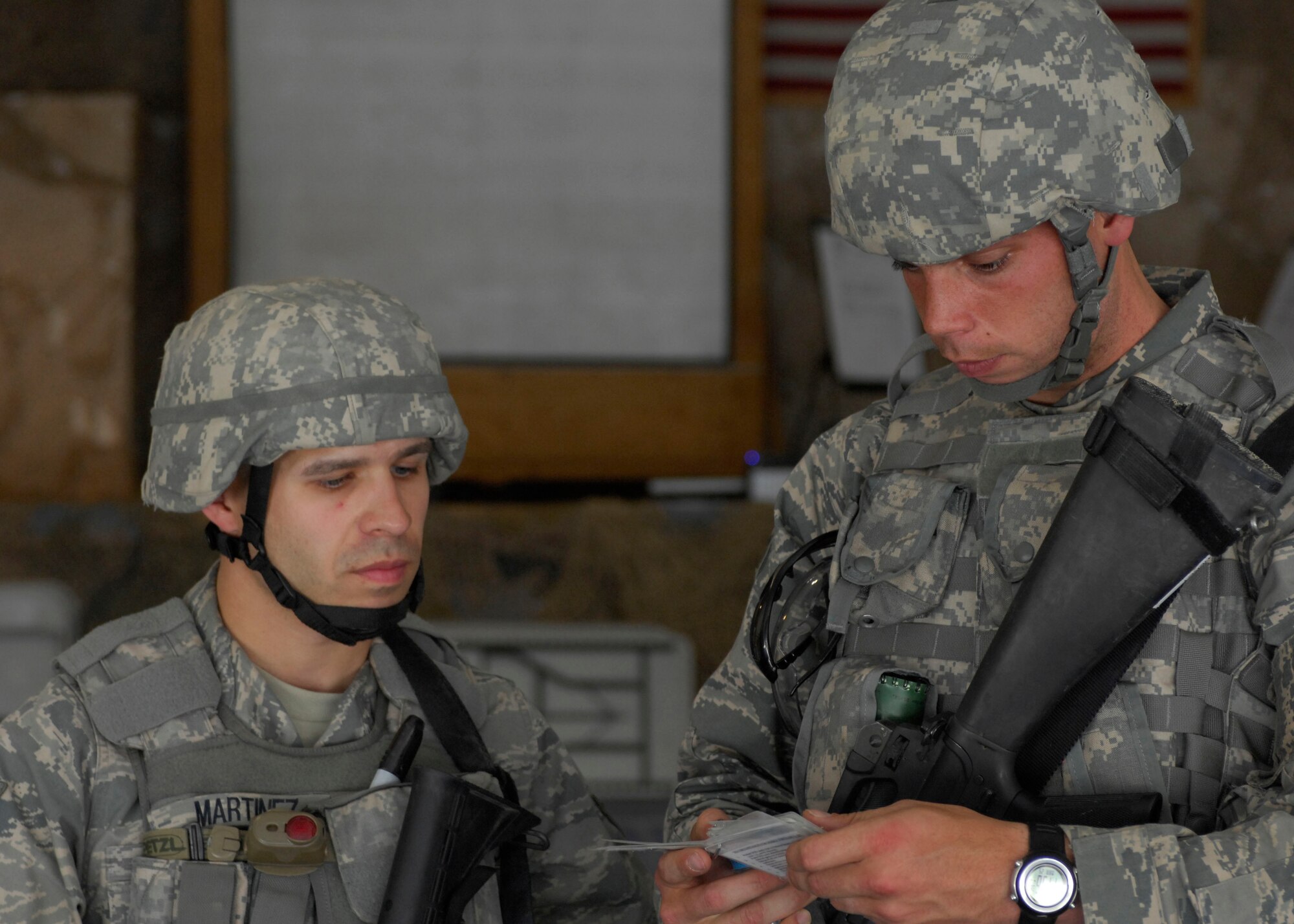 Staff Sgt. Dean Martinez, 455th Expeditionary Security Forces Squadron, and Senior Airman Steven Doty, 455th Expeditionary Civil Engineer Squadron force protection, discuss proper procedures for weapon assembly at Bagram Air Field, Afghanistan, March 25. The Combined Joint Task Force-101 held a competition for junior enlisted and non-commissioned officer Soldiers, Airmen, Sailors, and Marines. Sergeant Martinez placed first in the NCO category and Airman Doty finished in second in the junior enlisted category. The competition was held over two days and consisted of physical fitness, written evaluation on Code of Conduct and CJTF-101 history, hands-on combat skills, orienteering, and an evaluation board of five joint senior enlisted members.(U.S. Air Force photo/ Senior Airman Erik Cardenas)(Released)
