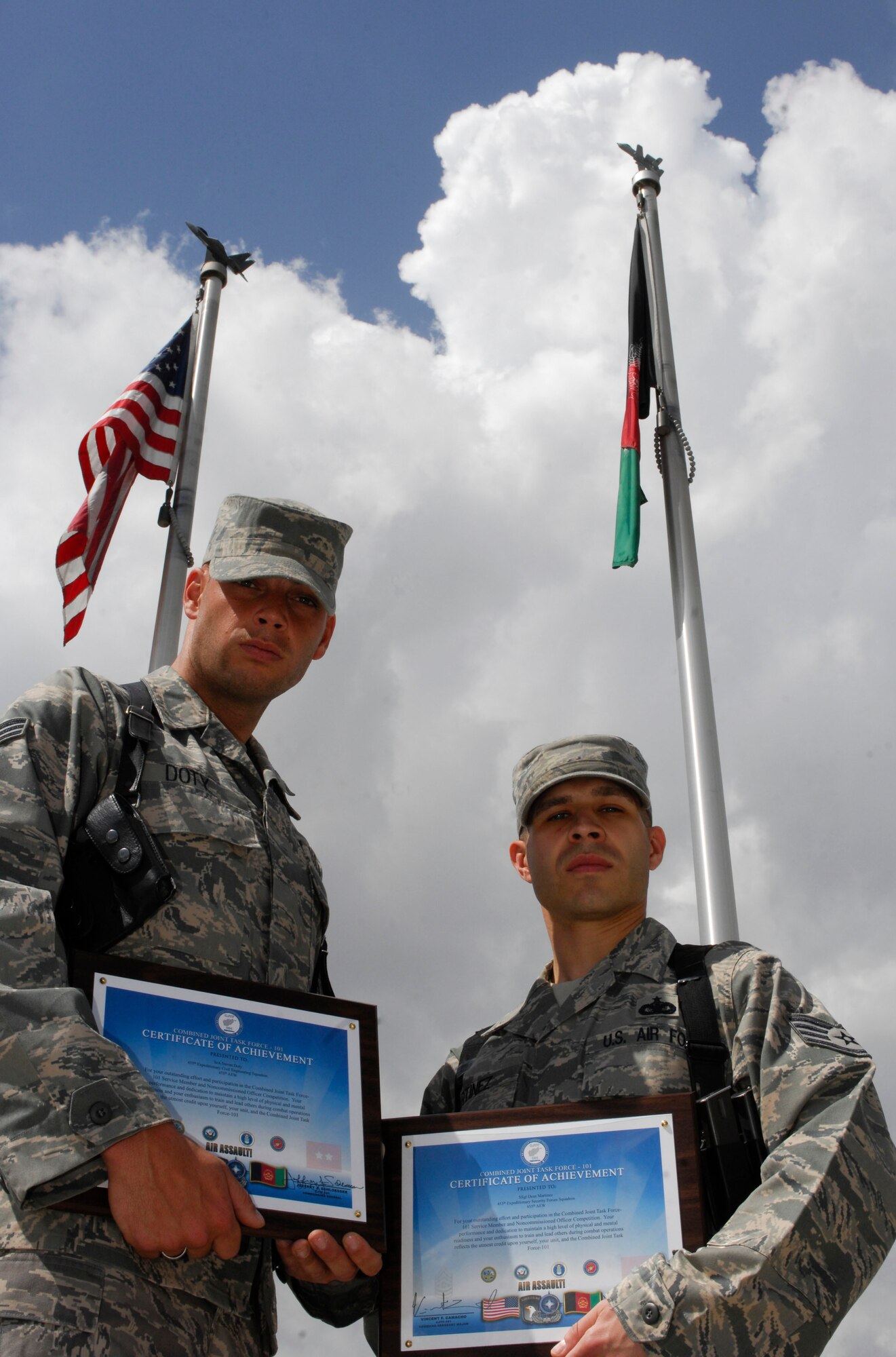 Senior Airman Steven Doty, 455th Expeditionary Civil Engineer Squadron force protection, and Staff Sgt. Dean Martinez, 455th Expeditionary Security Forces Squadron stand with their Combined Joint Task Force-101 certificate at Bagram Air Field, Afghanistan, March 27. The CJTF-101 held a competition for junior enlisted and non-commissioned officer Soldiers, Airmen, Sailors, and Marines. Airman Doty finished in second in the junior enlisted category and Sergeant Martinez placed first in the NCO category. The competition was held over two days and consisted of physical fitness, written evaluation on Code of Conduct and CJTF-101 history, hands-on combat skills, orienteering, and an evaluation board of five joint senior enlisted members. "Sergeant Martinez and Airmen Doty represent the very best in our great Air Force and their accomplishment shows that Airmen are all-in and ready to do whatever is asked of them," said Chief Master Sgt. Dennis Vannorsdall, 455th AEW, Command Chief. (U.S. Air Force photo/ Senior Airman Erik Cardenas)(Released)