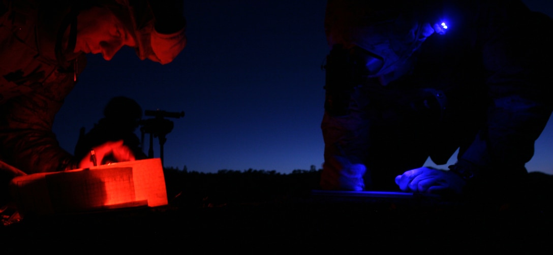 Maj. Brent Johnson (left) and Capt. Jonathan Marang (right) coordinate target information prior to calling in close-air support during an exercise here March 29. A detachment of Marines from 1st Air Naval Gunfire Liaison Company to the 11th Marine Expeditionary Unit direct and control air support and can call in indirect fire from artillery, naval guns and mortars. Johnson is the MEU’s air officer and Marang is the team leader of one of the MEU’s two fire control teams.