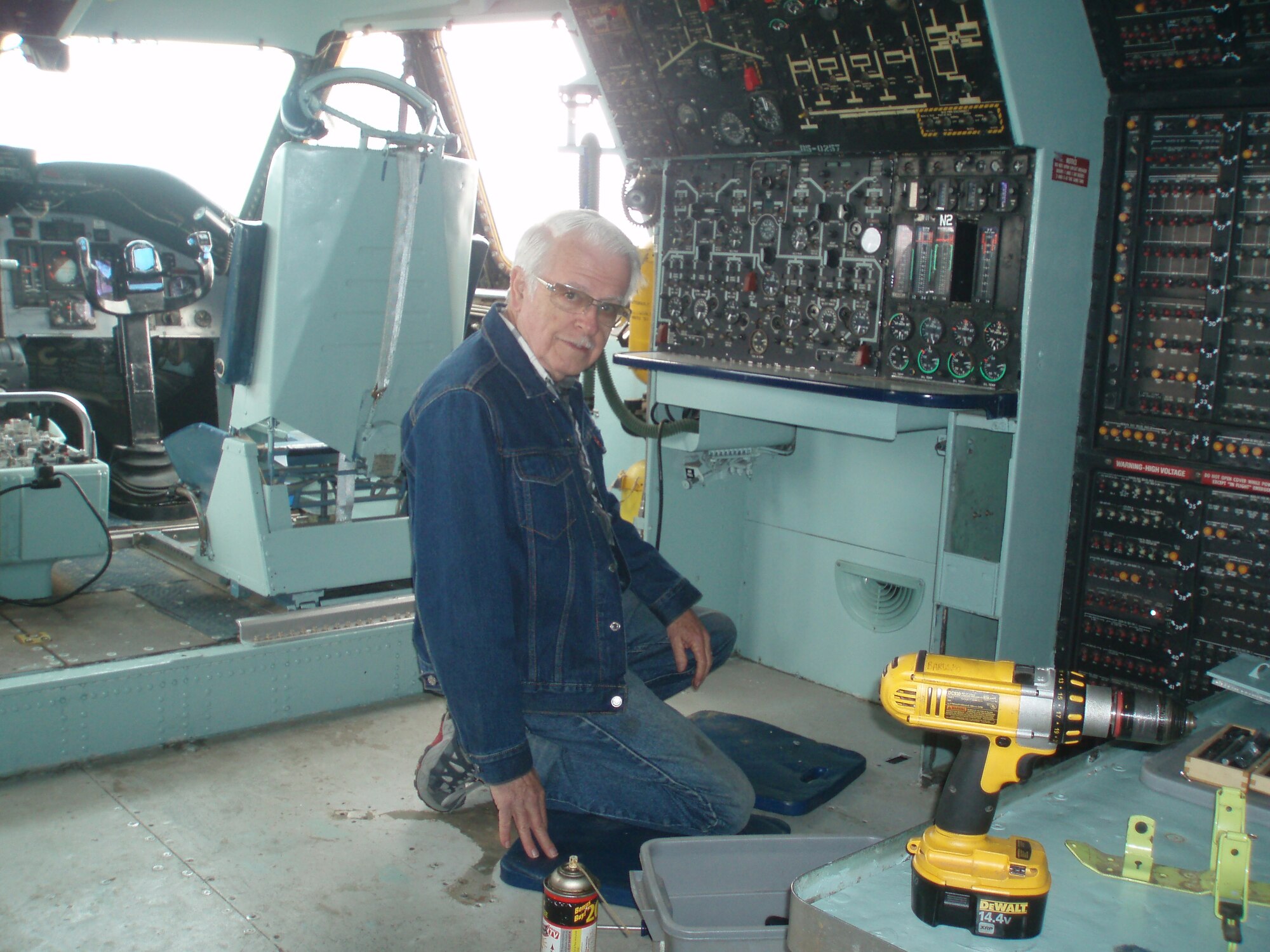 Chester Franklin is hard at work in the cockpit area. The C-141 is available for events which is why Jacob chose to fix it up. “I believed it would have the greatest impact for the base and community.” (Courtesy photo by Jacob Medeiros)