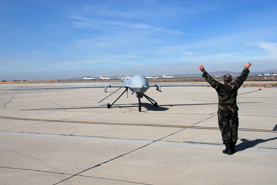 Master Sgt. Ron Doyle marshals in a Predator MQ-1 after its maiden flight. (U.S. Air Force photo by Senior Airman Paul Duquette)
