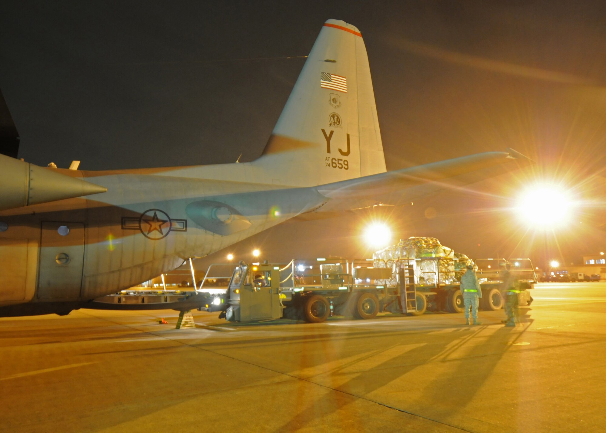 YOKOTA AIR BASE, Japan -- Members of the 36th Airlift Squadron and 730th Air Mobility Squadron, guide a pallet into the cargo compartment of a C-130 March 31 during Phase I of Exercise Beverly Morning 09-03.Yokota will be conducting the exersice March 30 through April 3 to maintain operational readiness. (U.S. Air Force photo/ Senior Airman Veronica Pierce)

