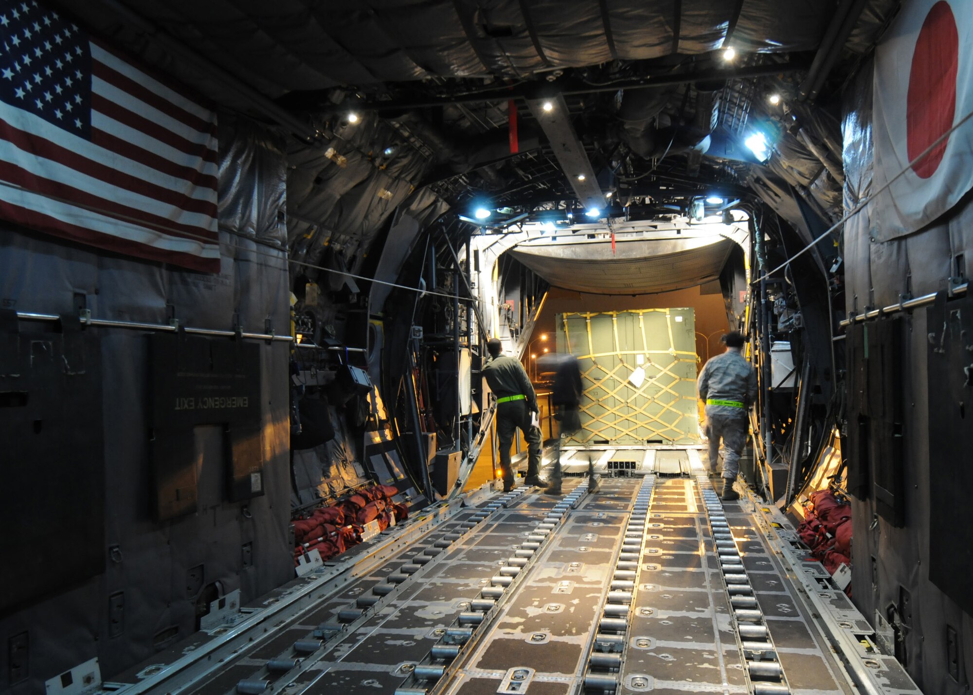 YOKOTA AIR BASE, Japan -- Members of the 36th Airlift Squadron and 730th Air Mobility Squadron, guide a pallet into the cargo compartment of a C-130 March 31 during Phase I of Exercise Beverly Morning 09-03. Yokota will be conducting the exersice March 30 through April 3 to maintain operational readiness. (U.S. Air Force photo/ Senior Airman Veronica Pierce)
