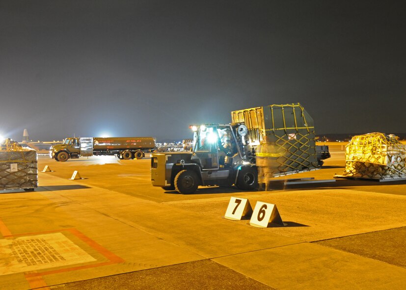 YOKOTA AIR BASE, Japan -- Members of the 374th Aircraft Maintenance Squadron and 730th Air Mobility Squadron prepare pallets March 31 for uploading to a C-130 aircraft during Phase I of Exercise Beverly Morning 09-03. Yokota is conducting an exercise March 30 through April 3 to maintain operational readiness. (U.S. Air Force photo/ Senior Airman Veronica Pierce)

