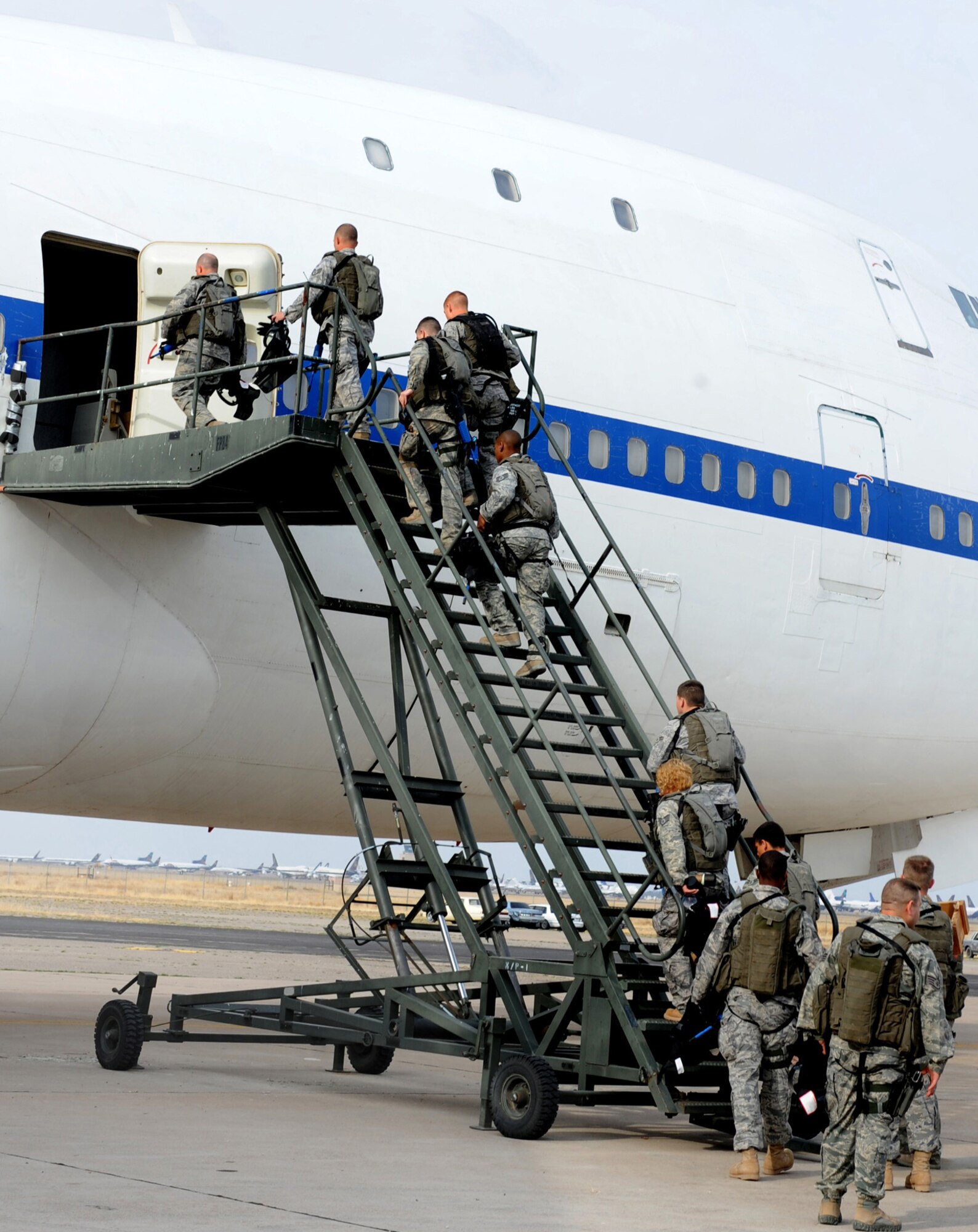 CANNON AIR FORCE BASE, N.M. -- Airmen from the 27th Special Operations Security Forces Squadron board a plane before "deploying" to a hostile "village" March 20. The exercise in Roswell, N.M., was the culmination of week-long training that thirteen Cannon Airmen participated in involving live explosions, simunitions rounds, and blanks. (U.S. Air Force photo/Airman 1st Class Evelyn Chavez)