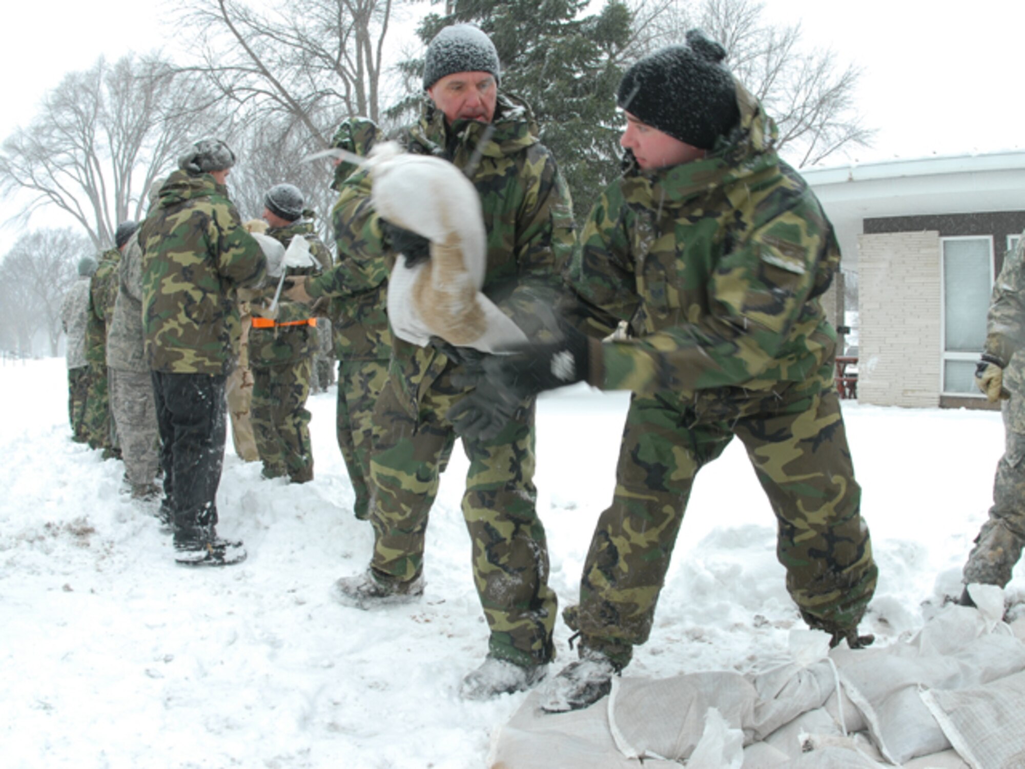 North Dakota National Guardsmen work on flood duty to combat the rising Red River in Fargo, North Dakota.  Over 3,000 soldiers and airmen from North Dakota and surrounding states work together to keep the state safe.  