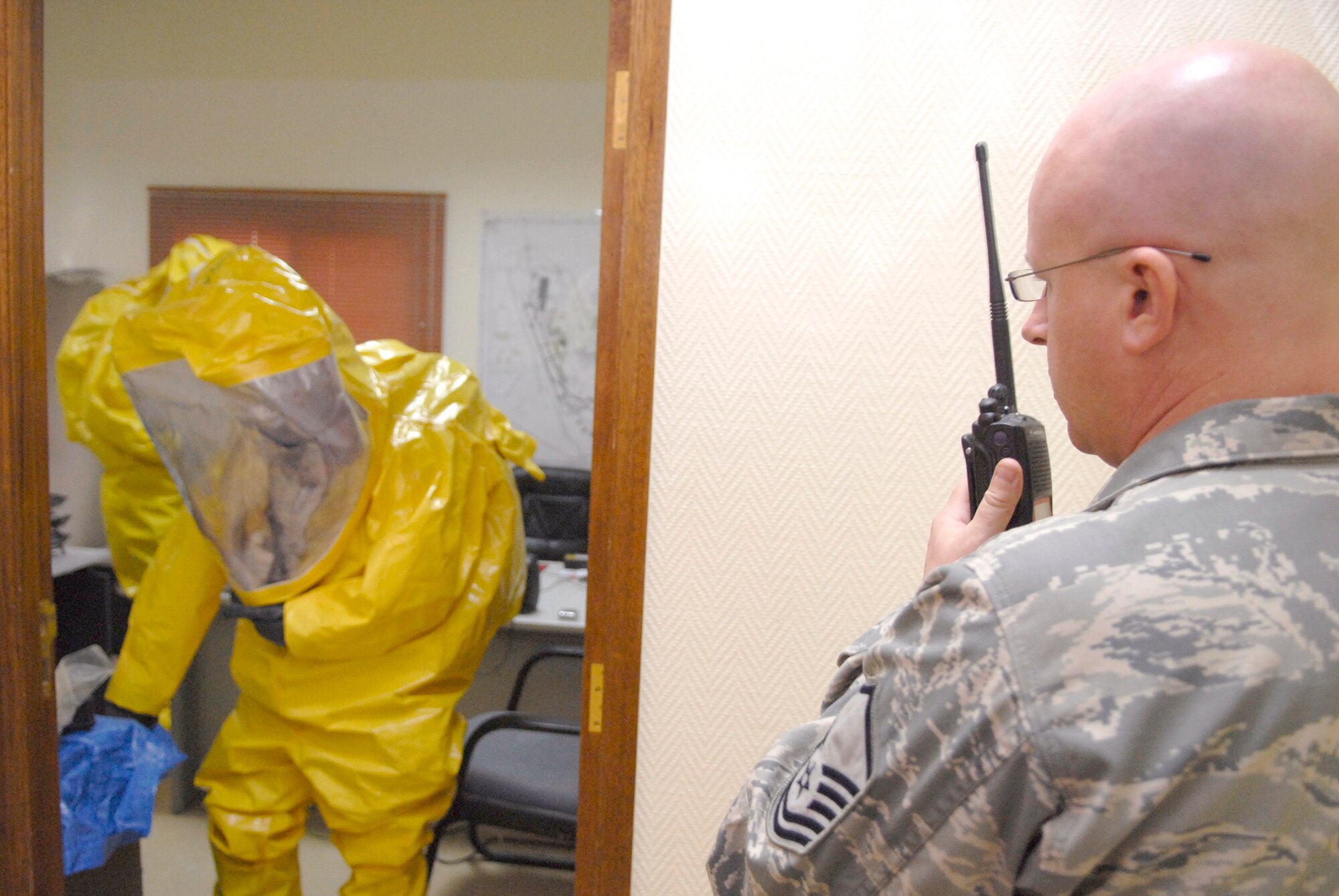 Master Sgt. John Werner provides communication and control for hazardous response survey team members during a unit mission readiness exercise March 27 at an air base in Southwest Asia.  In an actual hazardous situation, Sergeant Werner, the 379th Expeditionary Civil Engineer Squadron readiness and emergency management flight chief, would be physically separated from the survey team but would stay in communication and help develop a plan of attack for the possible contaminated location.  Sergeant Werner is from Kansas City, Kan., and is deployed from Anderson Air Force Base, Guam.  (U.S. Air Force photo/Senior Airman Andrew Satran)