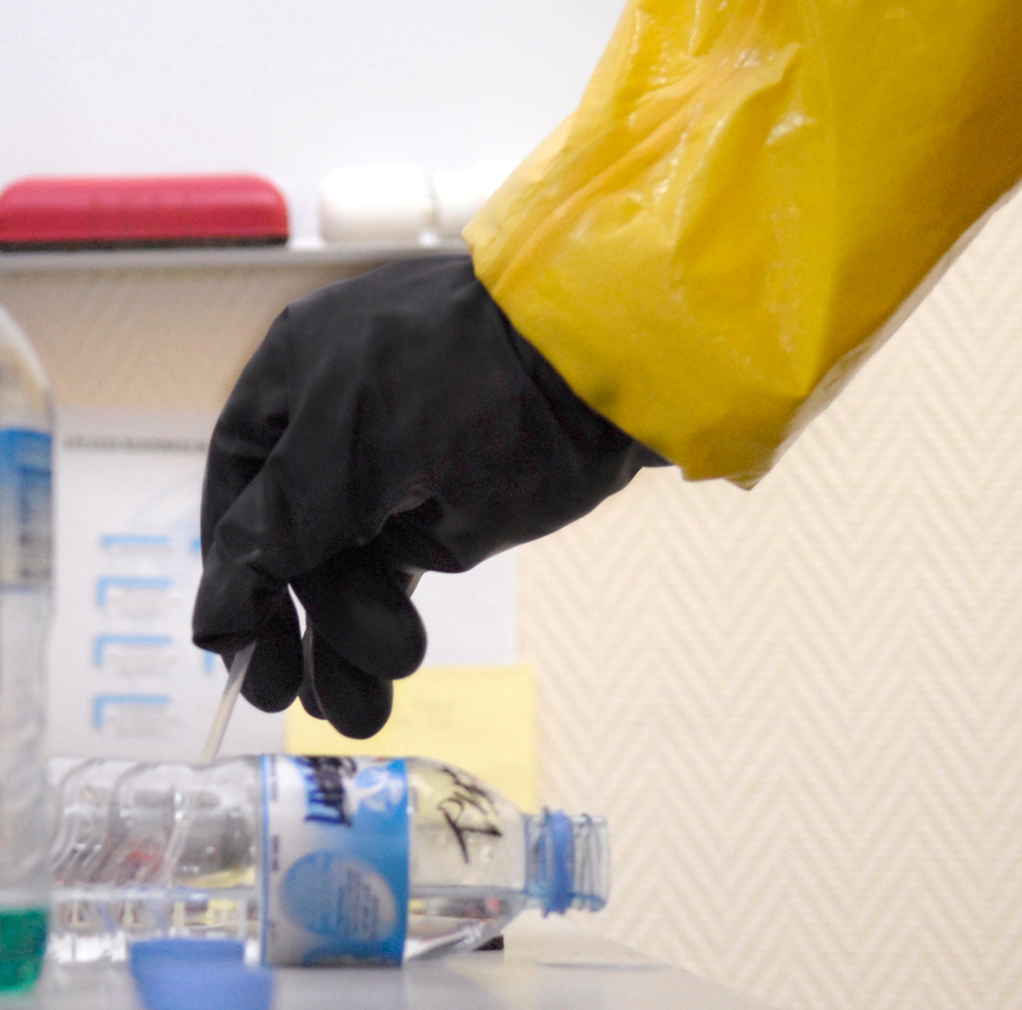 Staff Sgt. Trevor Fettig collects a liquid sample to analyze for contamination during a unit exercise March 27 at an air base in Southwest Asia.  Sergeant Fettig, a readiness and emergency management journeymen with the 379th Expeditionary Civil Engineer Squadron, hails from Lompoc, Calif., and is deployed from Travis Air Force Base, Calif.  (U.S. Air Force photo/Senior Airman Andrew Satran)
