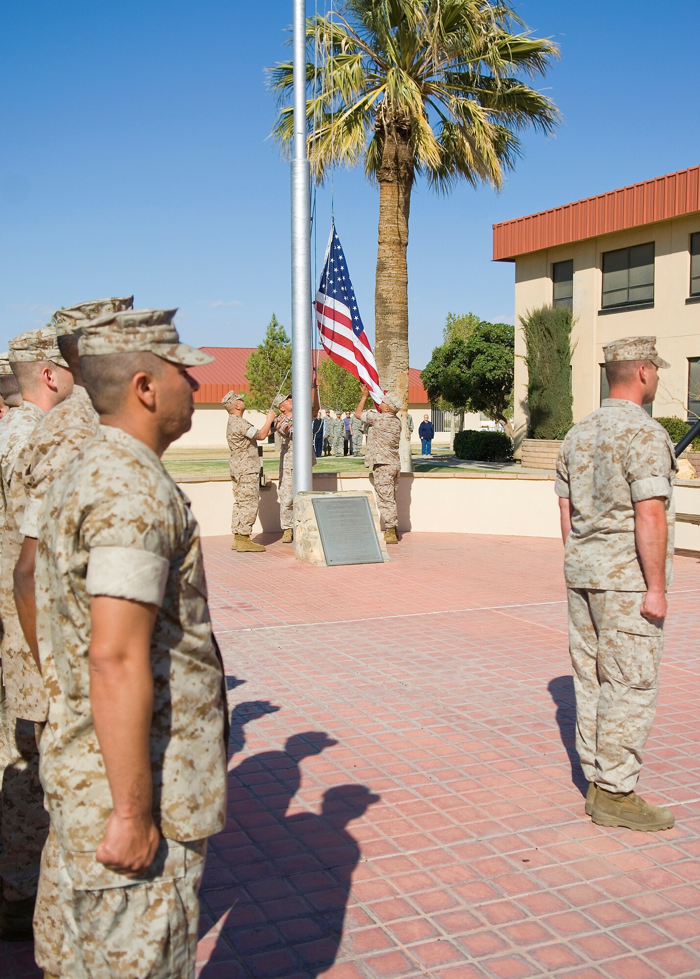 Marines assigned to Marine Aircraft Group 46 Detachment Bravo stand at attention as the flag was lowered during a retreat ceremony in front of Air Force Flight Test Center Headquarters March 26. (U.S. Air Force photo/Mike Cassidy)