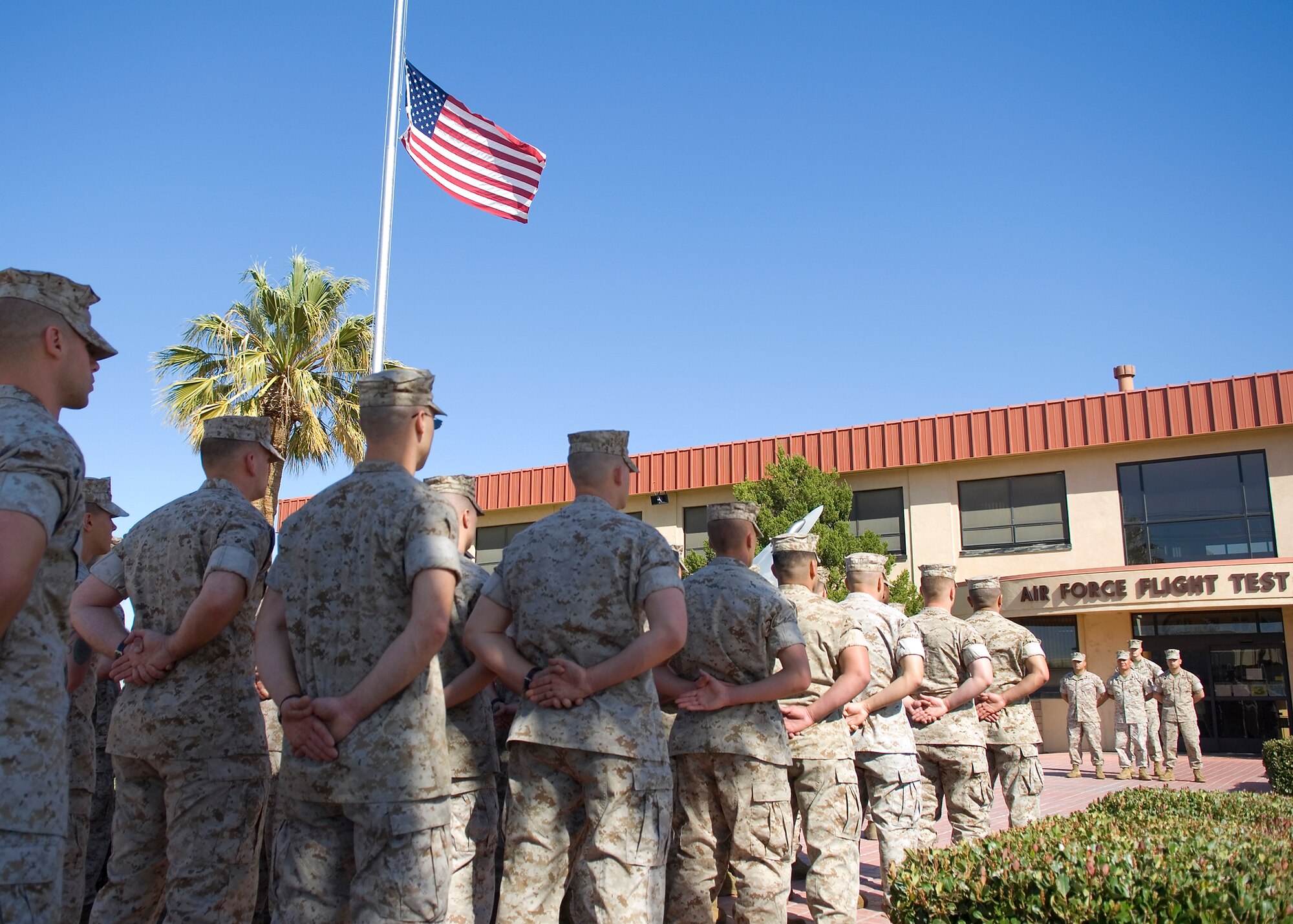 Marines assigned to Marine Aircraft Group 46 Detachment Bravo stand at parade rest during a retreat ceremony in front of Air Force Flight Test Center Headquarters March 26. (U.S. Air Force photo/Mike Cassidy)