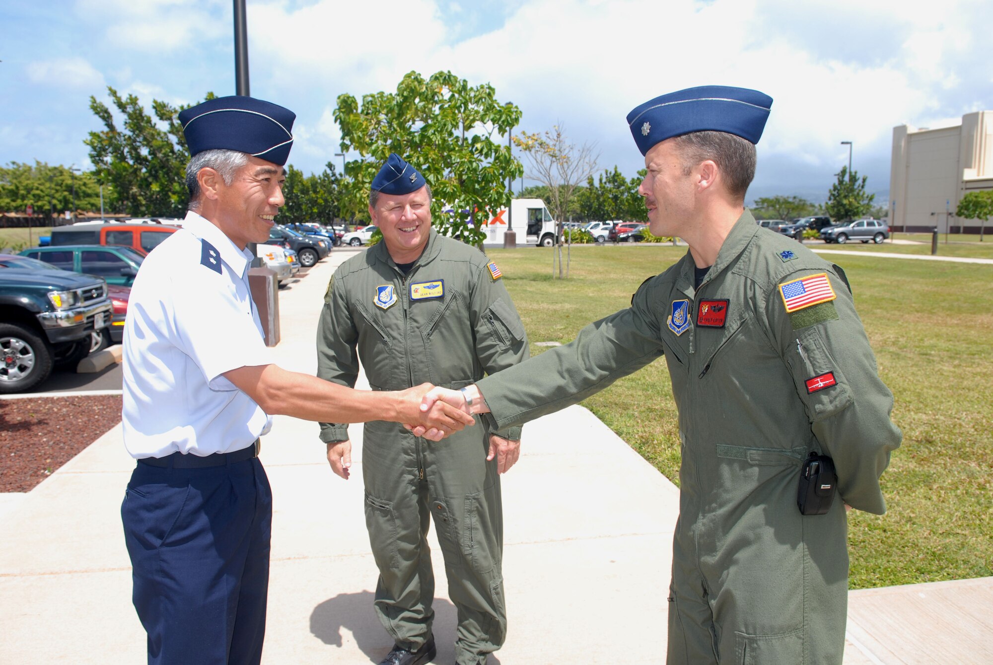 HICKAM AIR FORCE BASE, Hawaii -- Col. Dean Wolford, the 15th Air Wing vice commander, and Lt.  Col.  Casey Eaton, the 535th Airlift Squadron commander, welcome Maj. Gen. Kosuke Yoshida, the director of logistics, Japan Self Defense Force, Joint Staff, during his visit to Hickam Air Force Base, Hawaii, March 26. General Yoshida and other military officials from Australia and the United States met here during a three-day trilateral conference focused on security issues and mutual cooperation in international peacekeeping missions. The trilateral conference, held annually, also focused on acquisition and cross-servicing agreements, airlift cooperation, expeditionary logistic support, and air transportation of hazardous material.  This year’s conference was hosted by U.S. Pacific Command, U.S. Pacific Air Forces, and the 13th Air Force here. 