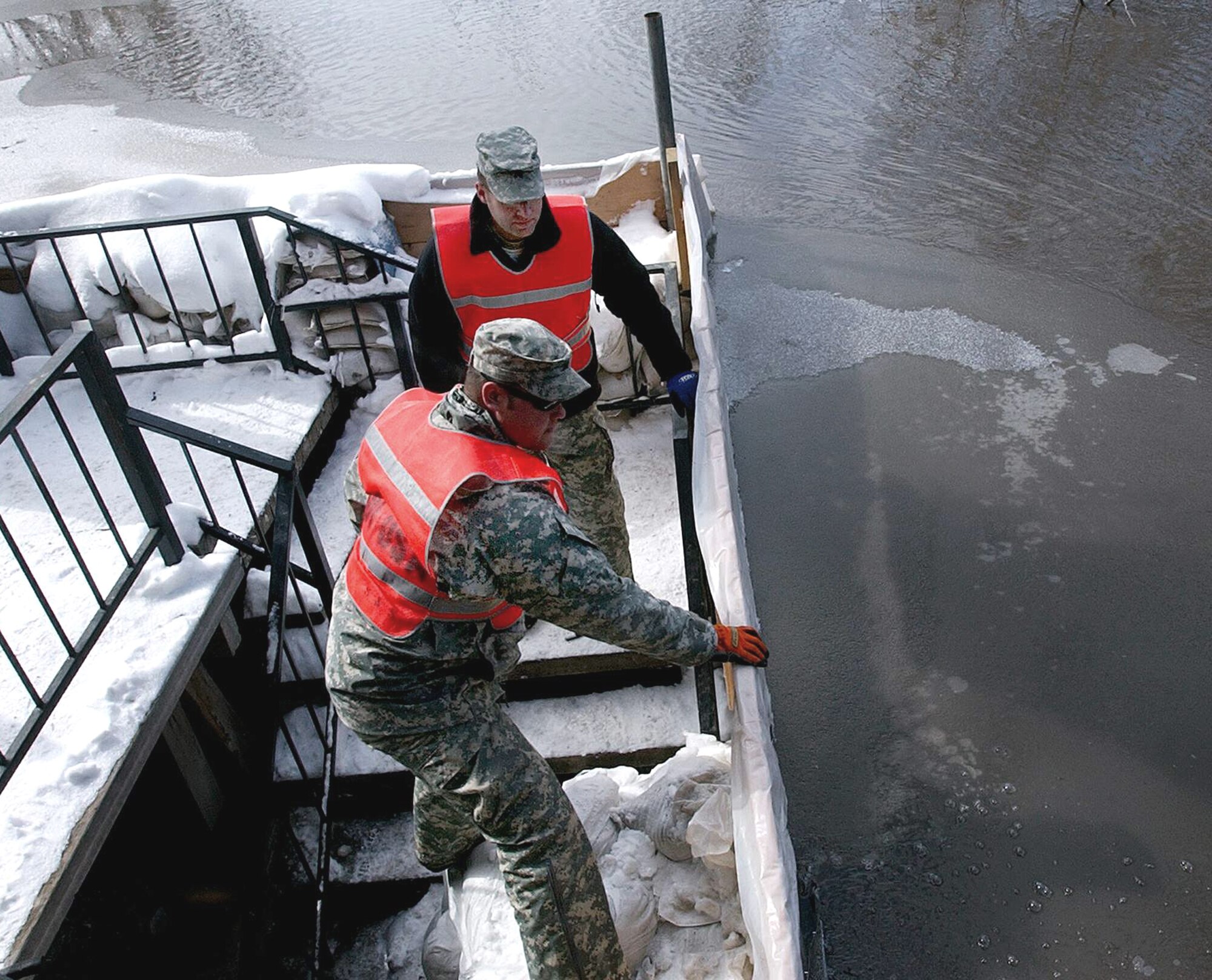 Soldiers check on flooding in a residential area along the Red River March 26 in Moorhead, Minn. As of March 30, governors in six upper Midwestern states have sent more than 2,400 National Guard members and equipment to help fight flooding in the area. The Soldiers are from Company A, 2nd Combined Arms Battalion, 136th Infantry Regiment. (U.S. Army photo/Staff Sgt. Jon Soucy)