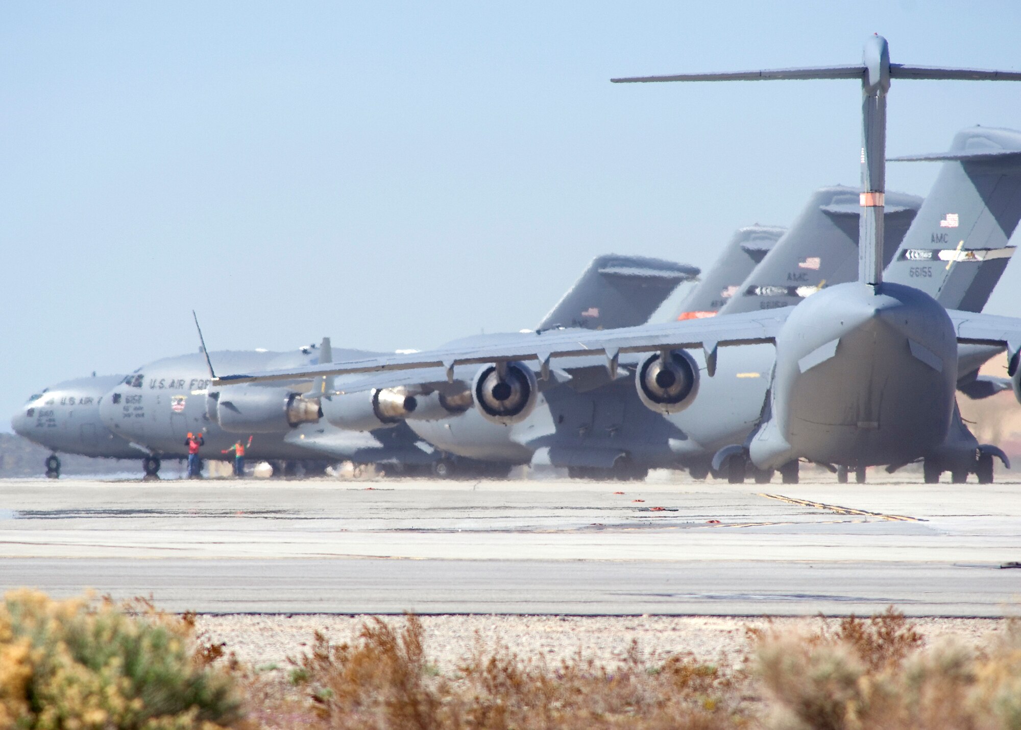 C-17 Globemaster IIIs at Edwards Air Force Base, Calif., taxi out for a six-ship formation testing mission. The C-17 is capable of rapid strategic delivery of troops and cargo to main operating bases or directly to forward bases in deployed environments. (U.S. Air Force photo/Mike Cassidy)