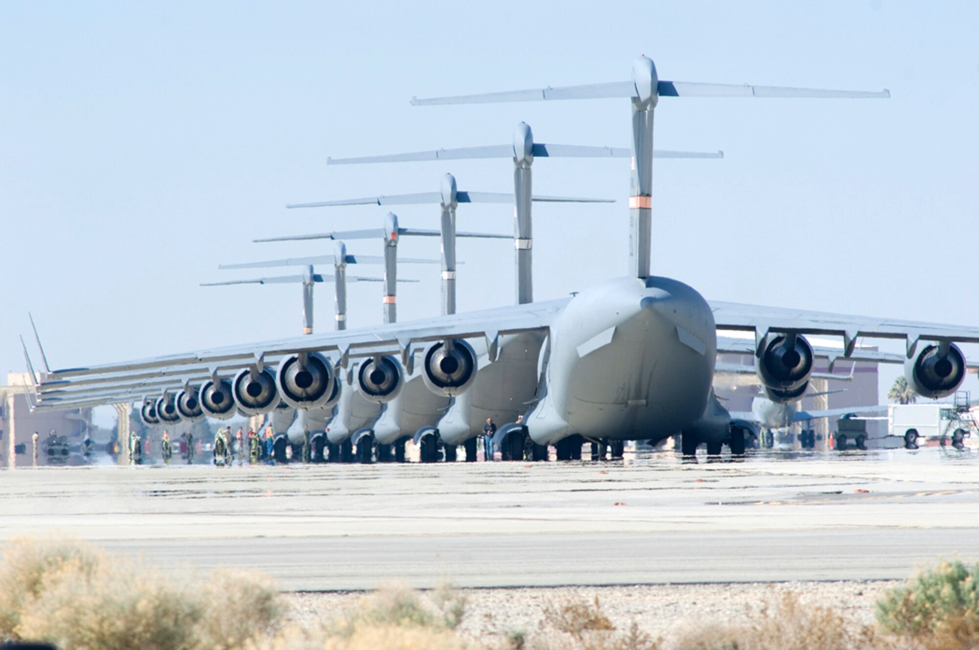 C-17 Globemaster IIIs sit on the flightline at Edwards Air Force Base, Calif., in preparation for six-ship formation testing. The C-17 is capable of rapid strategic delivery of troops and cargo to main operating bases or directly to forward bases in deployed environments. (U.S. Air Force photo/Mike Cassidy) 