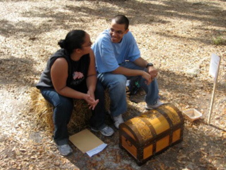 MOODY AIR FORCE BASE, Ga. -- Andrea Escobosa and Senior Airman Jose Escobosa, 23rd Wing Legal office, discuss the message for the "Treasure Chest" station during the marriage retreat hosted by the Base Chapel held at Hannan Ranch in Valdosta, Ga., March 21. The two-day retreat was aimed at coaching marriage through life transitions. (Courtesy photo)
