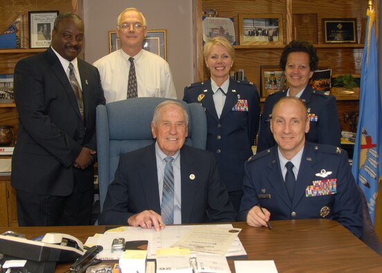 ALTUS AIR FORCE BASE, Okla. -- Col. David W. Allvin, 97th Air Mobility Wing commander and T.L. Gramling, Mayor of Altus, sign a proclamation designating April as Child Abuse Awareness Month in the city of Altus and on Altus Air Force Base.  Kevin Bell, Family Advocacy Outreach Manager; James Coffidis, Family Advocacy Treatment Manager; Col. Cheryl Gregorio, 97th  Medical Group commander and Lt. Col. Noemi Algarin-Lozano, 97th Medical Operations Squadron commander look on and call upon all citizens, community agencies, religious organizations, medical facilities and businesses to increase their participation in efforts to prevent child abuse, thereby strengthening the community in which we live. (U.S.Air Force photo/Senior Airman Jennifer L. Flores)