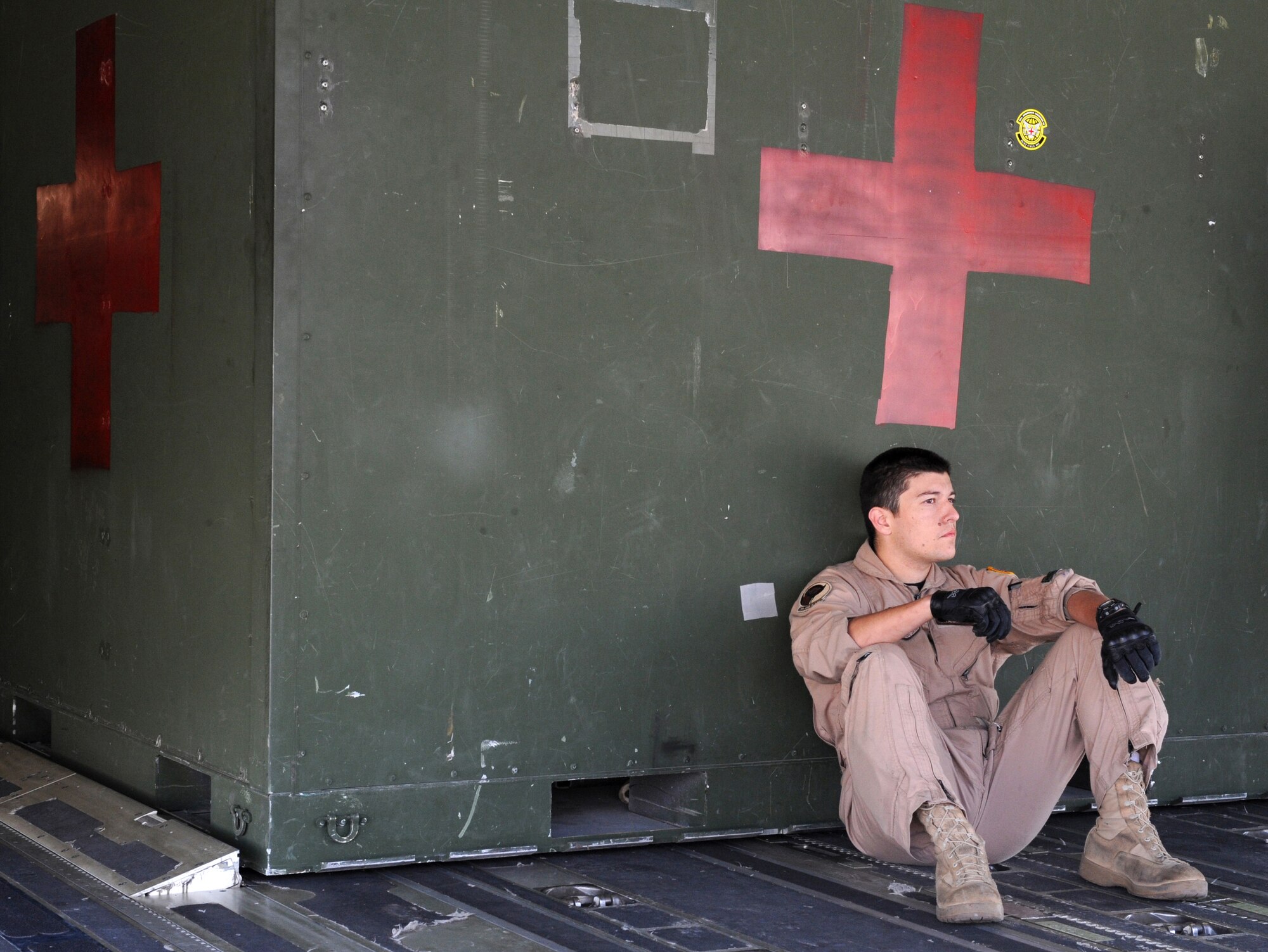 Senior Airman Andrew Chavez, a 729th Airlift Squadron loadmaster, waits for patients to be loaded onto a C-17 Globemaster III at Joint Base Balad, Iraq, on March 25, 2009. The 729th makes regular trips to Balad to pick up injured servicemembers. Airman Chavez is a native of Joshua Tree, Calif., and is an Air Force reservist from March Air Reserve Base, Calif. (U.S. Air Force photo/Senior Airman Tiffany Trojca)

