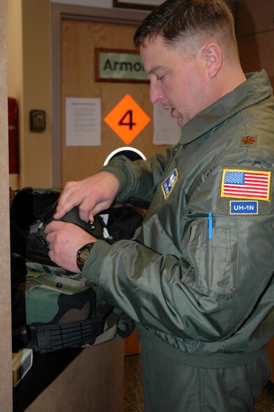 Major Kurt Geisen, 40th Helicopter Squadron pilot, gathers equipment at the 40th HS before an exercise flight Feb. 25. (U.S. Air Force photo/Senior Airman Dillon White)