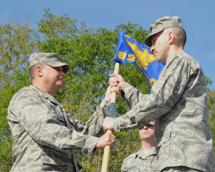 MOODY AIR FORCE BASE, Ga. -- (Left) Col. Donald Derry, 820th Security Forces Group commander, passes a new squadron guideon to Lt. Col. John Daberkow, the incoming 820th Combat Operations Squadron commander, during the unit activation ceremony here March 25. The new squadron will increase the effectiveness of the overall 820th SFG by providing vital services to deployed Airmen. (U.S. Air Force photo by Senior Airman Javier Cruz Jr.)