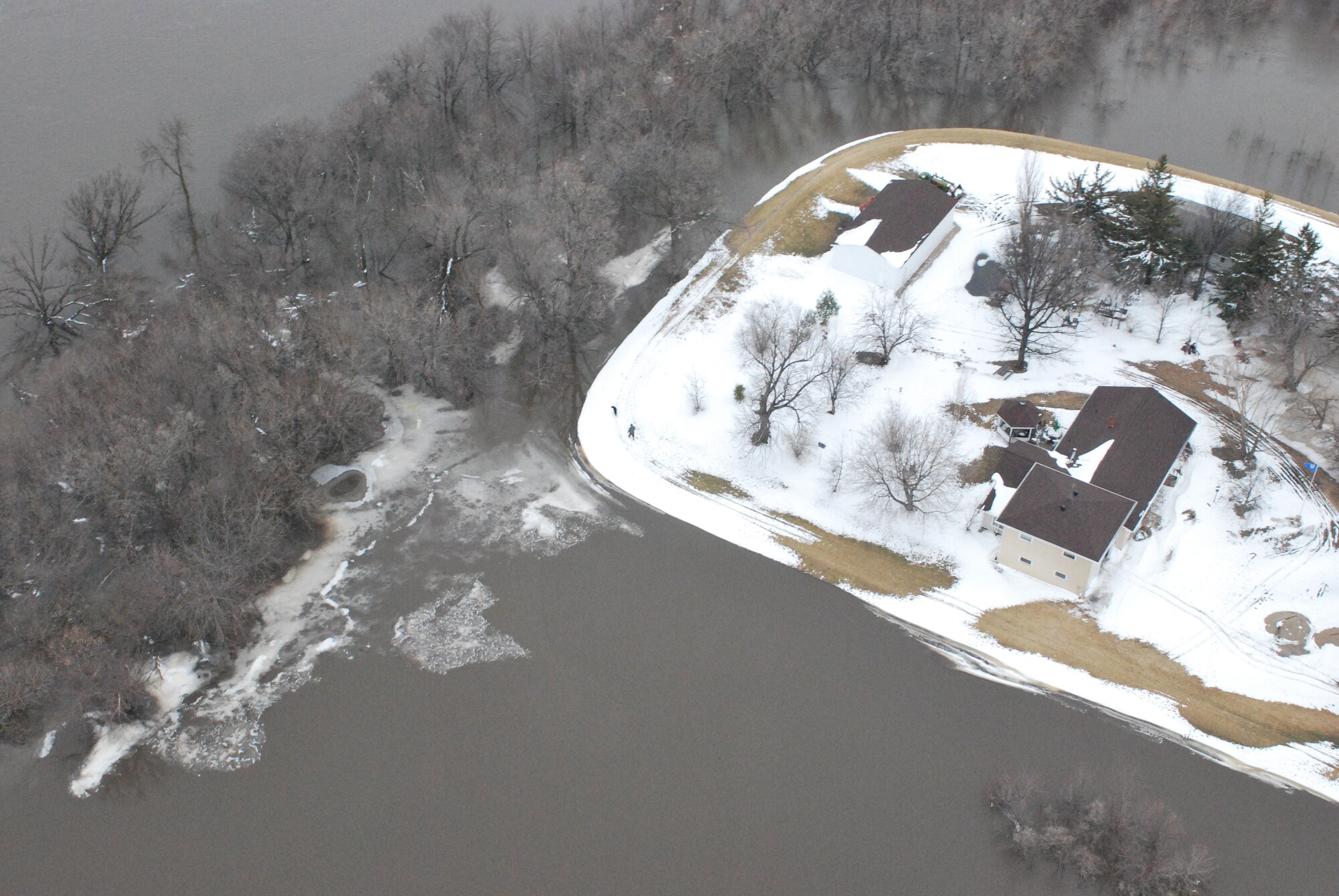 FARGO, N.D. – An over-head photo of one of the many homes hoping to ride out the recent flooding here March 29 along the Red River north of Fargo, N.D. Currently, the 54th Helicopter Squadron from Minot AFB has two UH-1N "Huey" crews at Grand Forks AFB, N.D., on alert to provide search and rescue missions in support of flood relief along the Red River. (U.S. Air Force photo by Airman 1st Class Joshua Rosales)