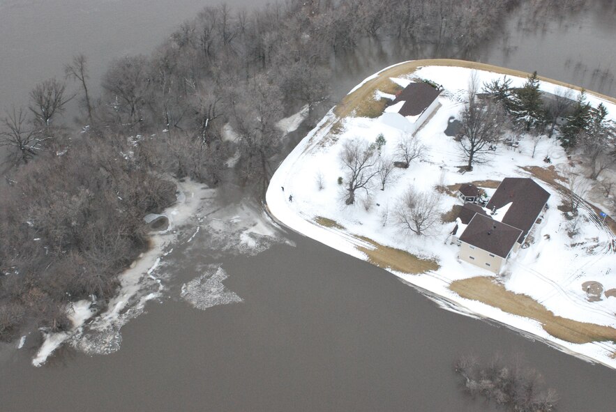 FARGO, N.D. – An over-head photo of one of the many homes hoping to ride out the recent flooding here March 29 along the Red River north of Fargo, N.D. Currently, the 54th Helicopter Squadron from Minot AFB has two UH-1N "Huey" crews at Grand Forks AFB, N.D., on alert to provide search and rescue missions in support of flood relief along the Red River. (U.S. Air Force photo by Airman 1st Class Joshua Rosales)