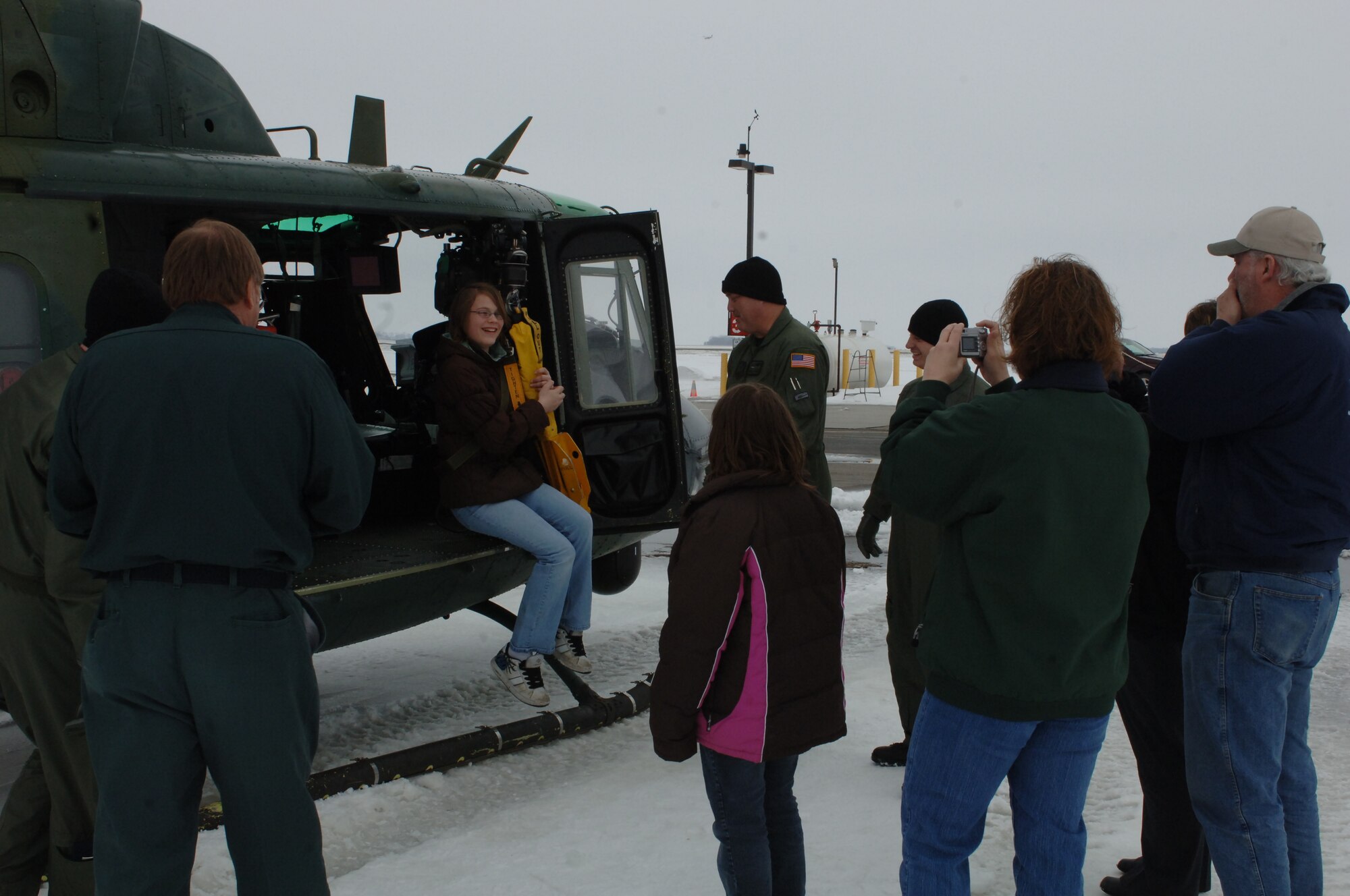 HILLSBORO, N.D. – A UH-1N "Huey" crew from Minot AFB’s 54th Helicopter Squadron show community members from Hillsboro, N.D., the Lucas hoist system which can be used to perform search and rescue missions March 29. The crew was at Hillsboro Regional Airport in support of flood relief efforts along the Red River. (U.S. Air Force photo by Airman 1st Class Joshua Rosales)