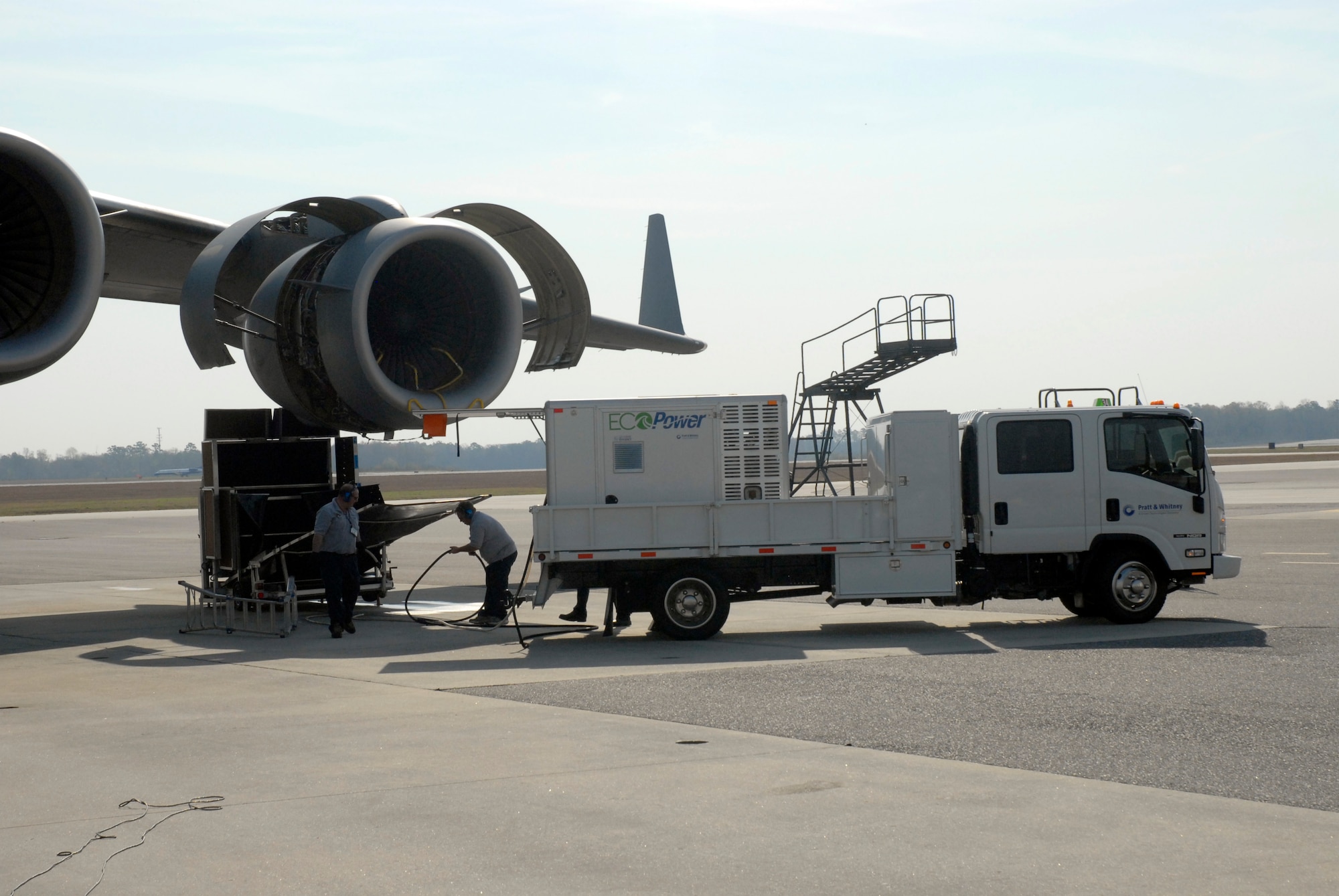 Contractors wash a Charleston AFB C-17 engine with the EcoPower Engine Wash
System, a new, environmentally friendly engine wash, March. 12. The
closed-loop system collects and recycles the runoff water, keeping
potentially contaminated water off of the flightline and running off into
the surrounding areas.(U.S. Air Force Photo/Staff Sgt. Robert Sizelove)  


