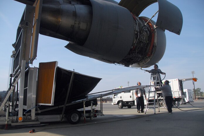 Contractors wash a Charleston AFB C-17 engine with the new
environmentally-friendly EcoPower Engine Wash System March 12. The
closed-loop system uses atomized water, collects the effluent water and
purifies it for recycled use. (U.S. Air Force photo/Staff Sgt. Robert Sizelove)
