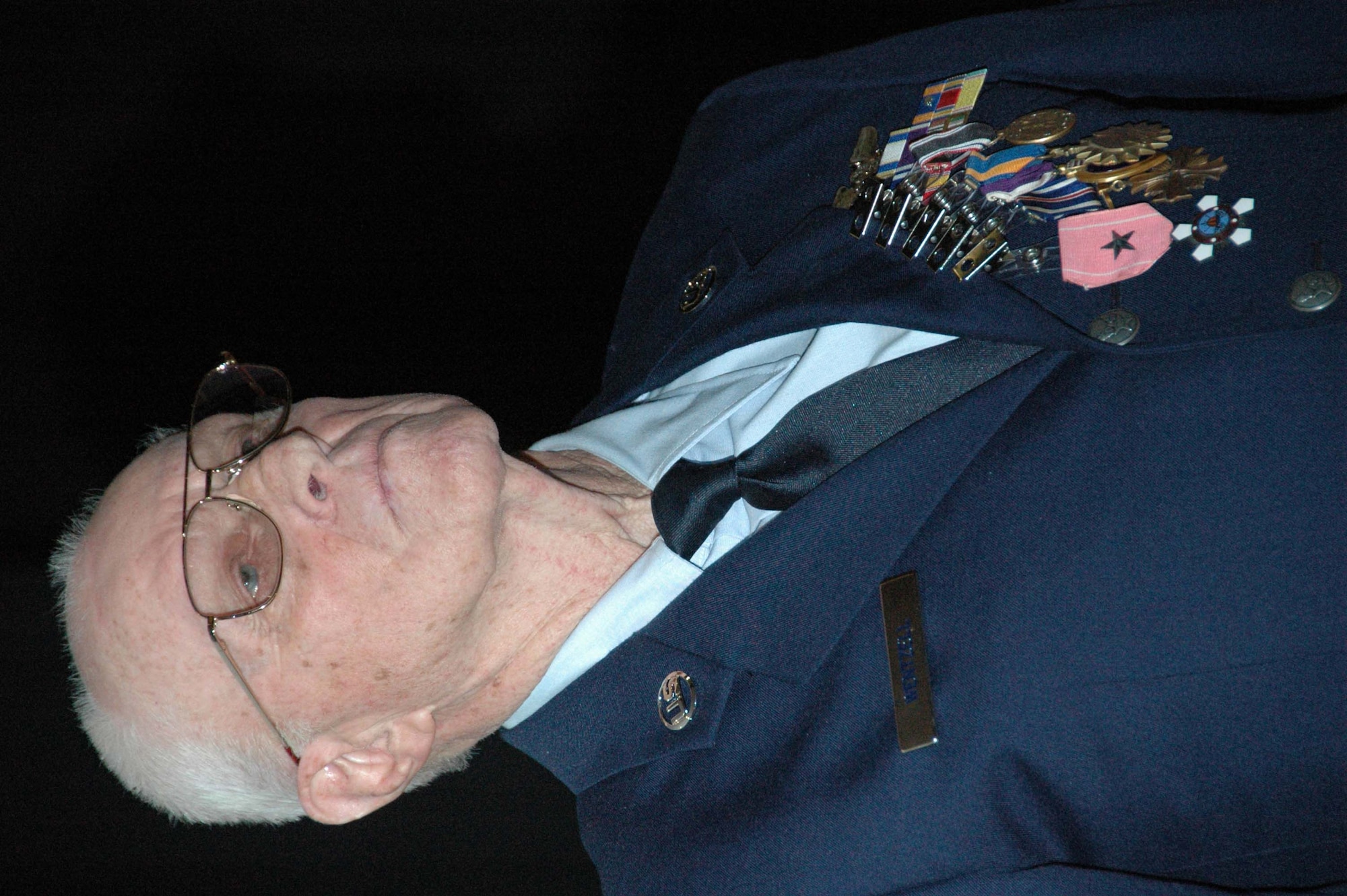 MCGUIRE AIR FORCE BASE, N.J. -- Tech. Sgt., retired, Charles E. Wentzell listens to and watches as he's given a standing ovation March 22 at the Timmermann Conference Center on Fort Dix, N.J. The World War II veteran and Ex-POW formally received seven medals he earned more than 56 years ago during his military service that included duty with the Army, Army Air Corps and the Air Force. (U.S. Air Force photo/Master Sgt. Charles Kramer)