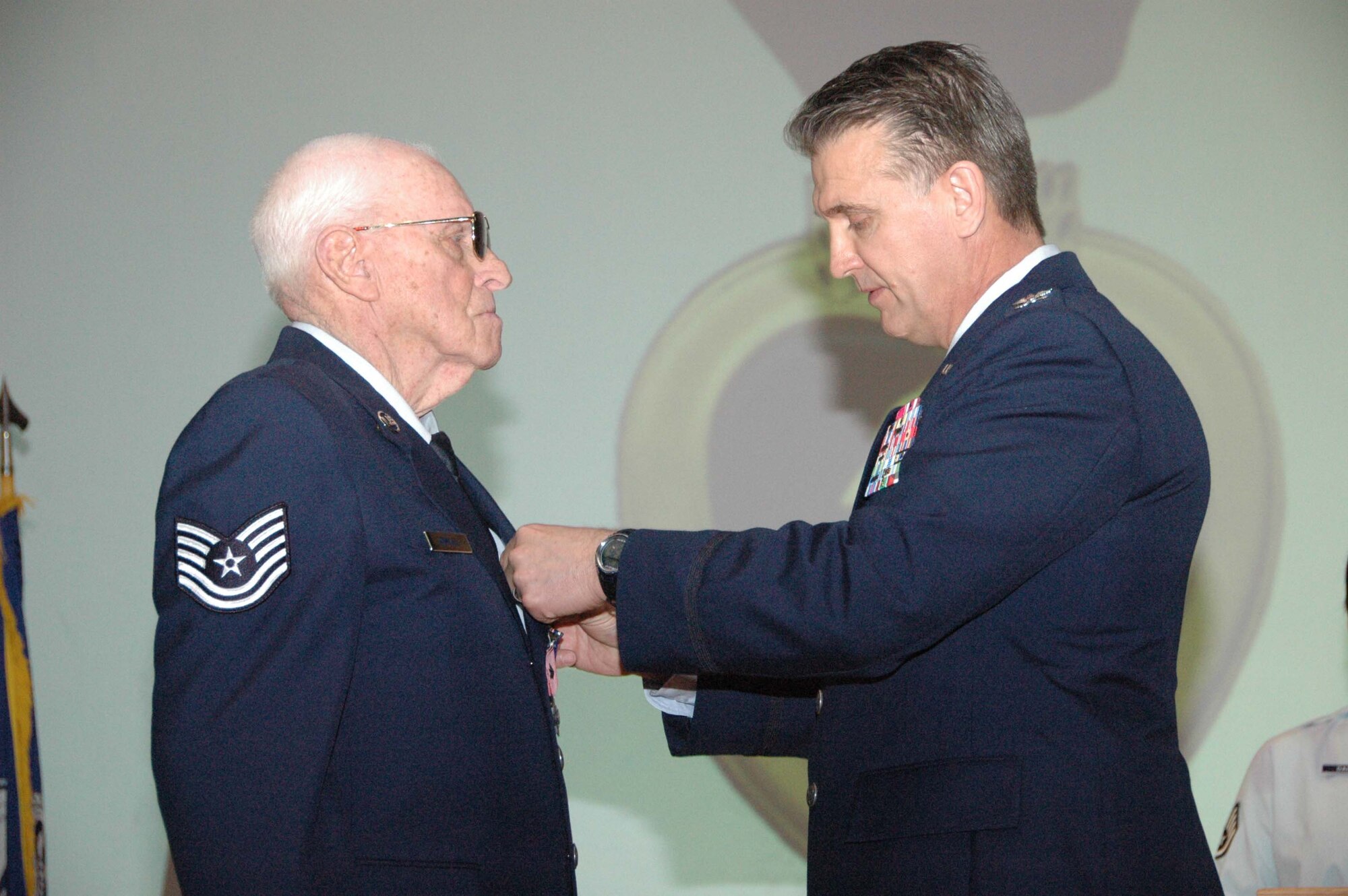 MCGUIRE AIR FORCE BASE, N.J. -- Tech. Sgt., retired, Charles E. Wentzell is pinned with the Purple Heart from Col. Giordano McMullen, vice wing commander, 514th Air Mobility Wing on March 22 at the Timmermann Conference Center on Fort Dix, N.J. The World War II veteran and Ex-POW formally received seven medals he earned more than 56 years ago during his military service that included duty with the Army, Army Air Corps and the Air Force. (U.S. Air Force photo/Master Sgt. Charles Kramer)