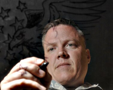 Master Sgt. Cody Vance, superintendant of the 59th Medical Wing Medical Multimedia Center, works on one of his many graphic arts projects.  Sergeant Vance was recently named military graphics artist of the year for the second year in a row. (U.S. Air Force photo/Senior Airman Robert Barnett)  