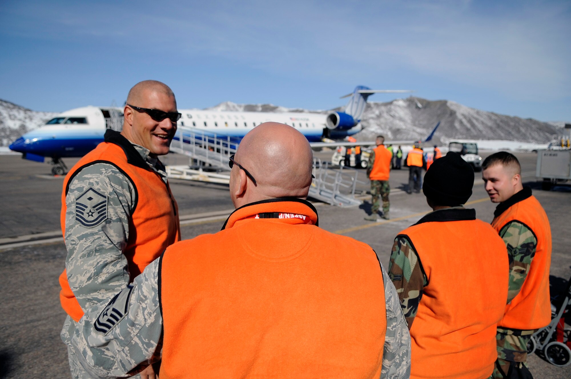 Airmen from Luke Air Force Base, Ariz. wait to escort veterans off a United aircraft March 28 at the Aspen Airport, Colo. Veterans from all over the world fly into Aspen to attend the Disabled American Veterans Winter Sports Clinic. (U.S. Air Force photo/Staff Sgt. Desiree N. Palacios)

