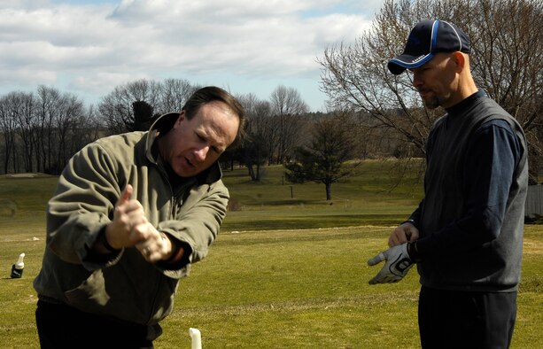 HANSCOM AIR FORCE BASE, Mass. – John Kan (left), Patriot Golf Course manager, offers some tips to John Macsata, 66th Mission Support Squadron, to help get his swing in shape for the 2009 opening of the Patriot Golf Course. The course is set to open April 10, for more information call (781) 687-2396. (U.S. Air Force photo by Linda LaBonte Britt)