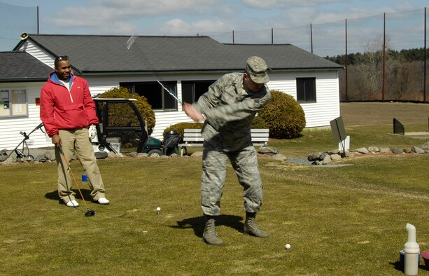 HANSCOM AIR FORCE BASE, Mass. –Staff Sgt. Michael Stephens (left), 66th Mission Support Group watches as Staff Sgt. Sean Heffernan, 66th Mission Support Squadron, takes some practice swings at the Patriot Golf Course, March 24. Golfers are getting ready for the course’s season opening on April 10. For more information on the Patriot Golf Course call (781) 687-2396 or go online to www.hanscomservices.com. (U.S. Air Force photo by Linda LaBonte Britt) 